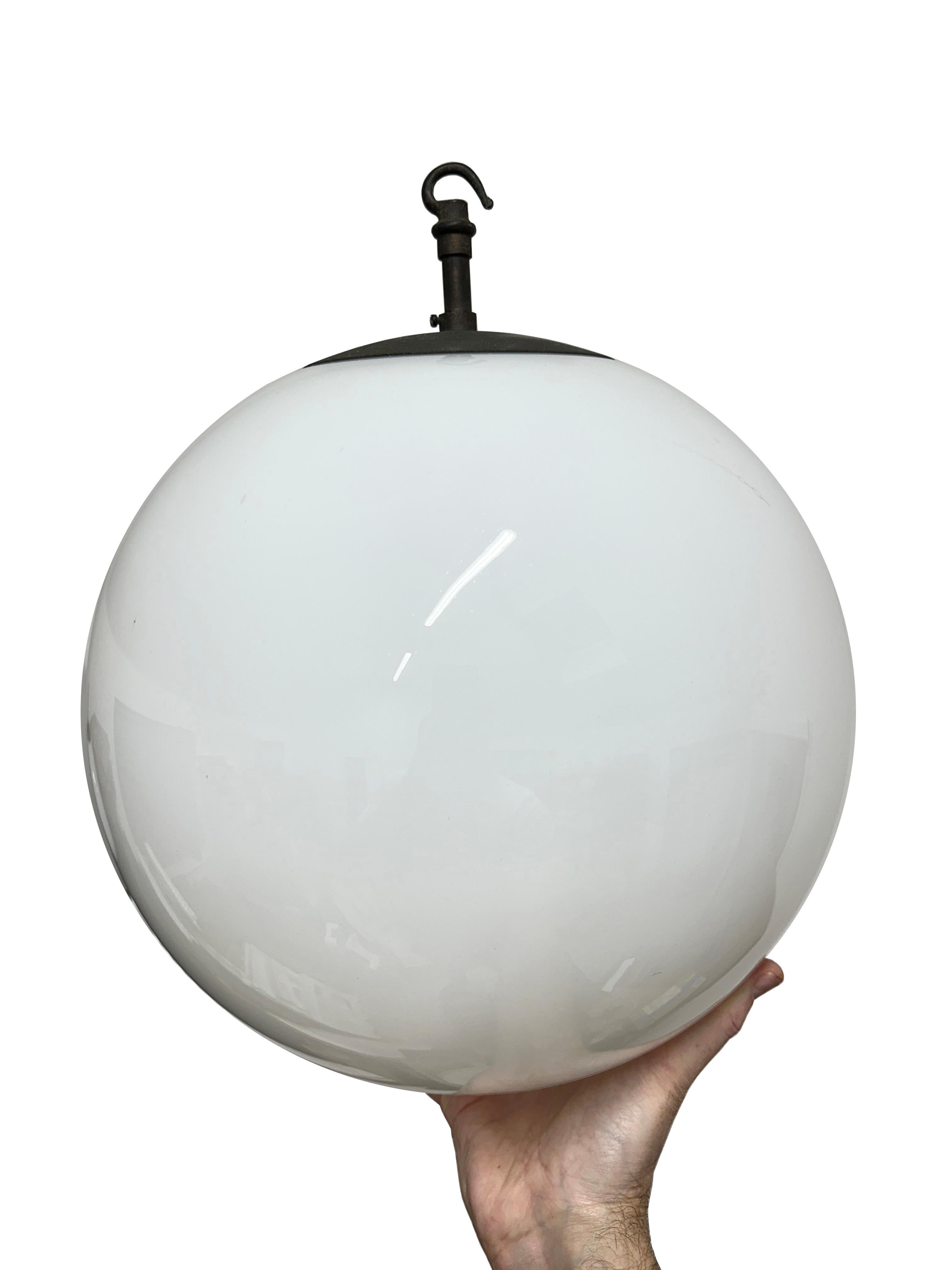- A large antique church opaline globe ceiling pendant, England circa 1930.
- Wonderful bulbous glass globe encompassing a patinated monks cap copper gallery,   these beautiful opaline pendants graced the inside of a church many years ago.  
-