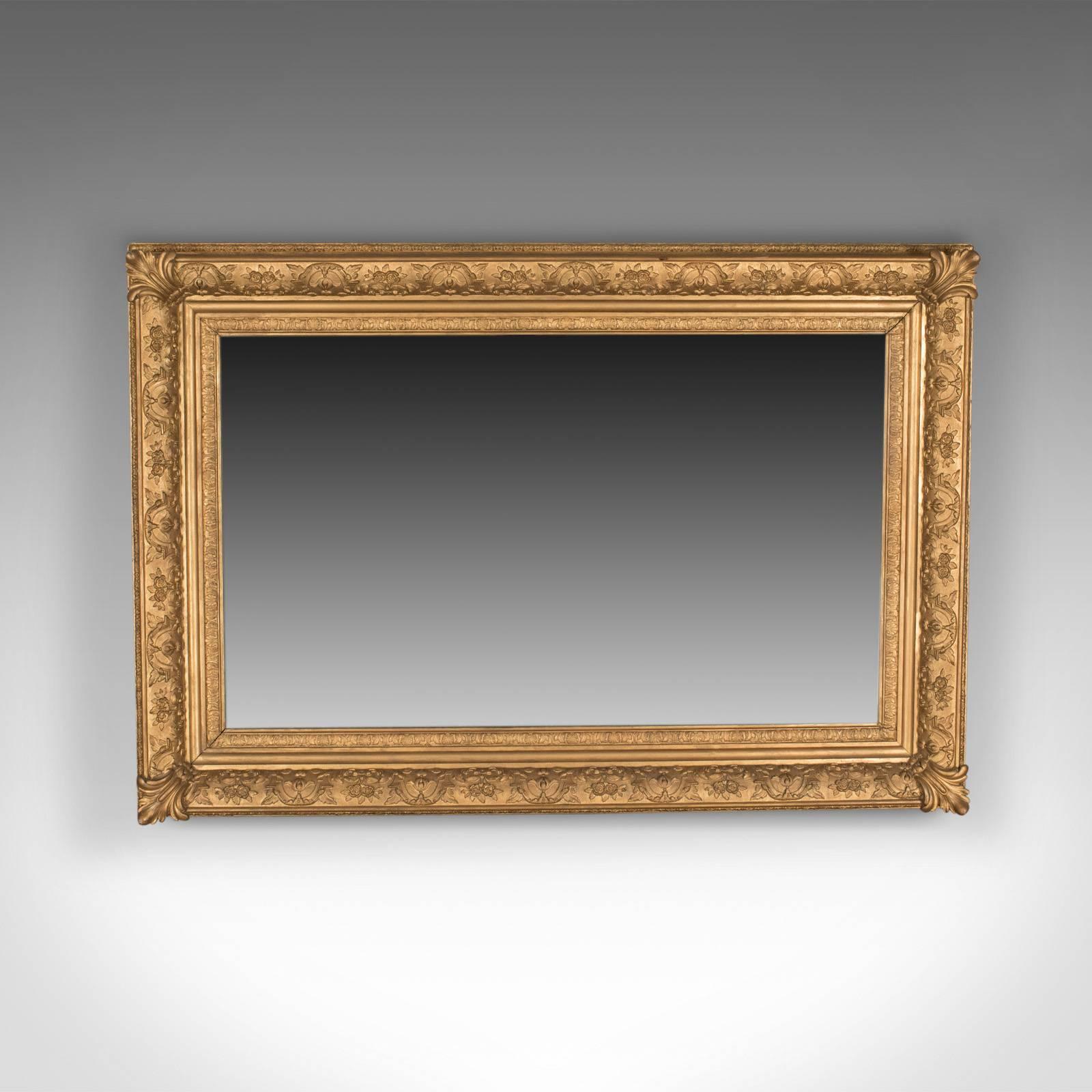 This is a large antique wall mirror, an English, Victorian gilt gesso frame, an overmantel dating to circa 1880.

A super period gilt gesso frame
Victorian in the classical taste
Decorated with floral and foliate detail
Later mirror plate in