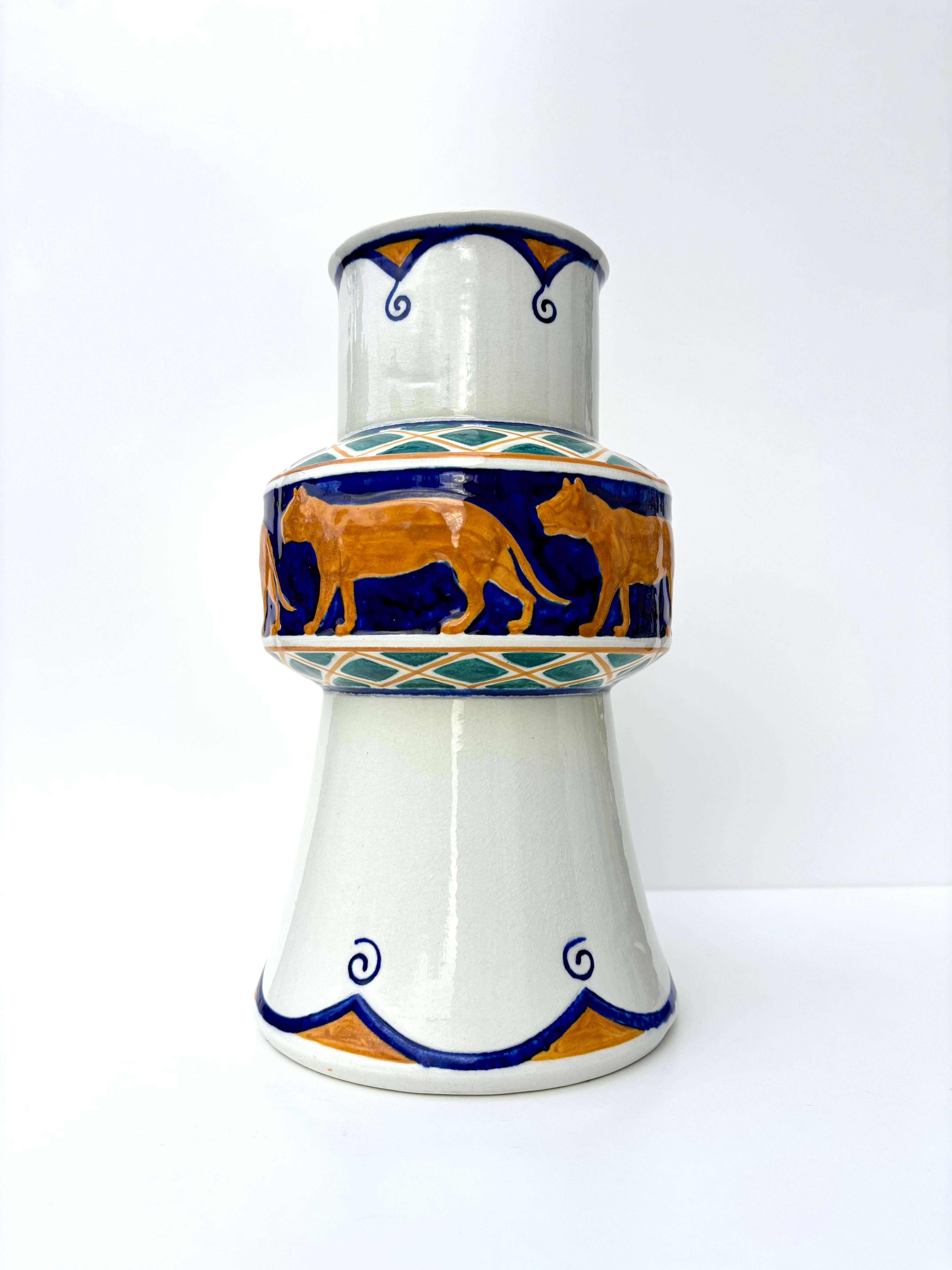 Swedish antique Art Nouveau period vase by Alf Wallander (1862-1914) for Rörstrand. Cream white glaze with a band of orange ochre lions on shiny kobalt blue background. Organic and geometric hand-painted decorations in ochre, blue and forest green