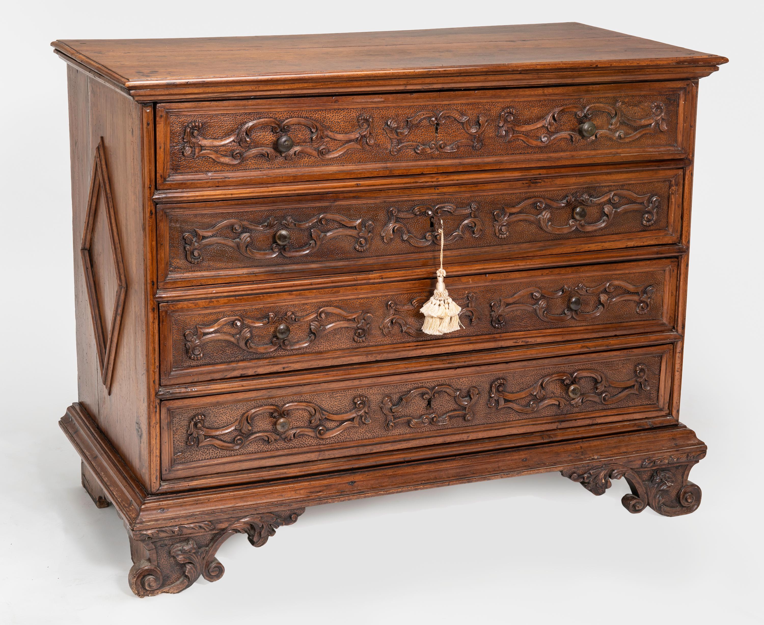 Magnificent, early 19th century, beautifully carved walnut chest of drawers. Probably from Northern France. Measures: 55” wide, 42” high, 24” deep. Four large carved front drawers. Carved feet and simple carved triangular panel sides. Most beautiful