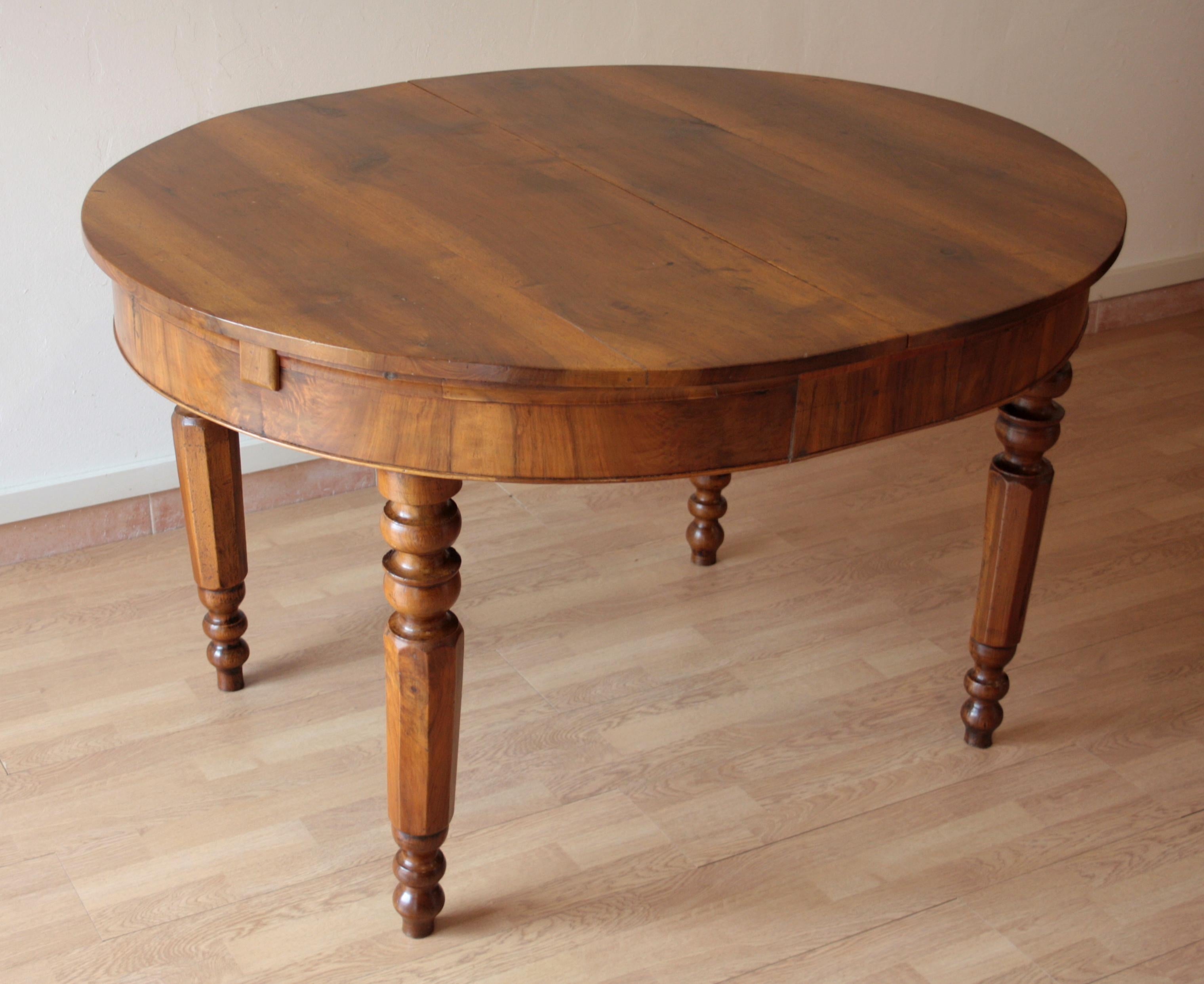 Beautiful original solid walnut table from the late 19th century. Built in southern Italy. Walnut legs turned. Extendable with original walnut extensions. Dimensions, when opened with extensions, the table top becomes 170 cm long x 110 cm wide.