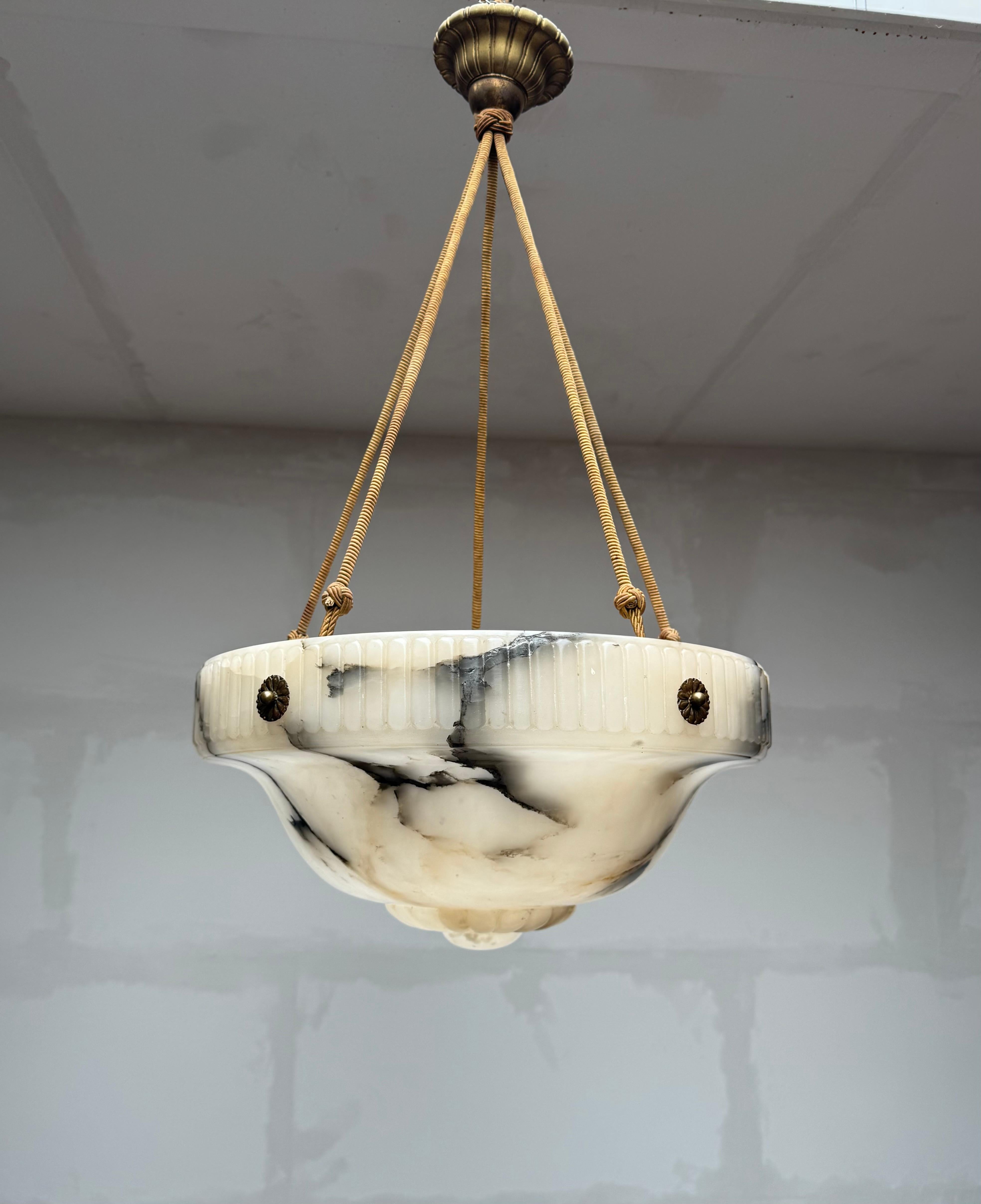 Top class, hand carved two-light alabaster chandelier.

Thanks to its unique design, aesthetic beauty, large size and great condition this antique alabaster chandelier is bound to light up both your days and evenings. It is all hand-crafted in the