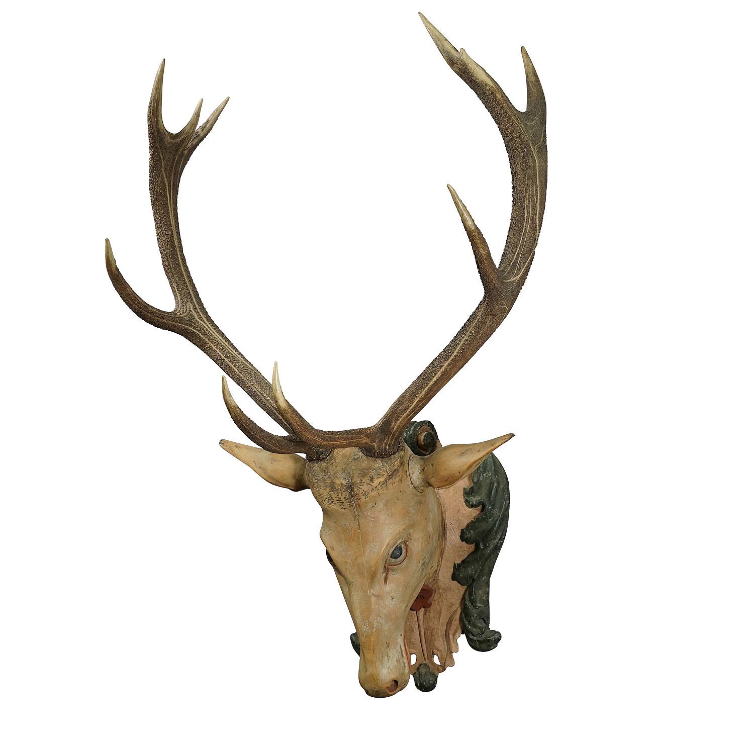 Large Antique Wooden Carved Black Forest Baroque stag head with 10 Point Trophy

A large antique Black Forest baroque stag head. Carved in typical abstract style of the early 18th century. It is mounted on a wooden carved and painted plaque with