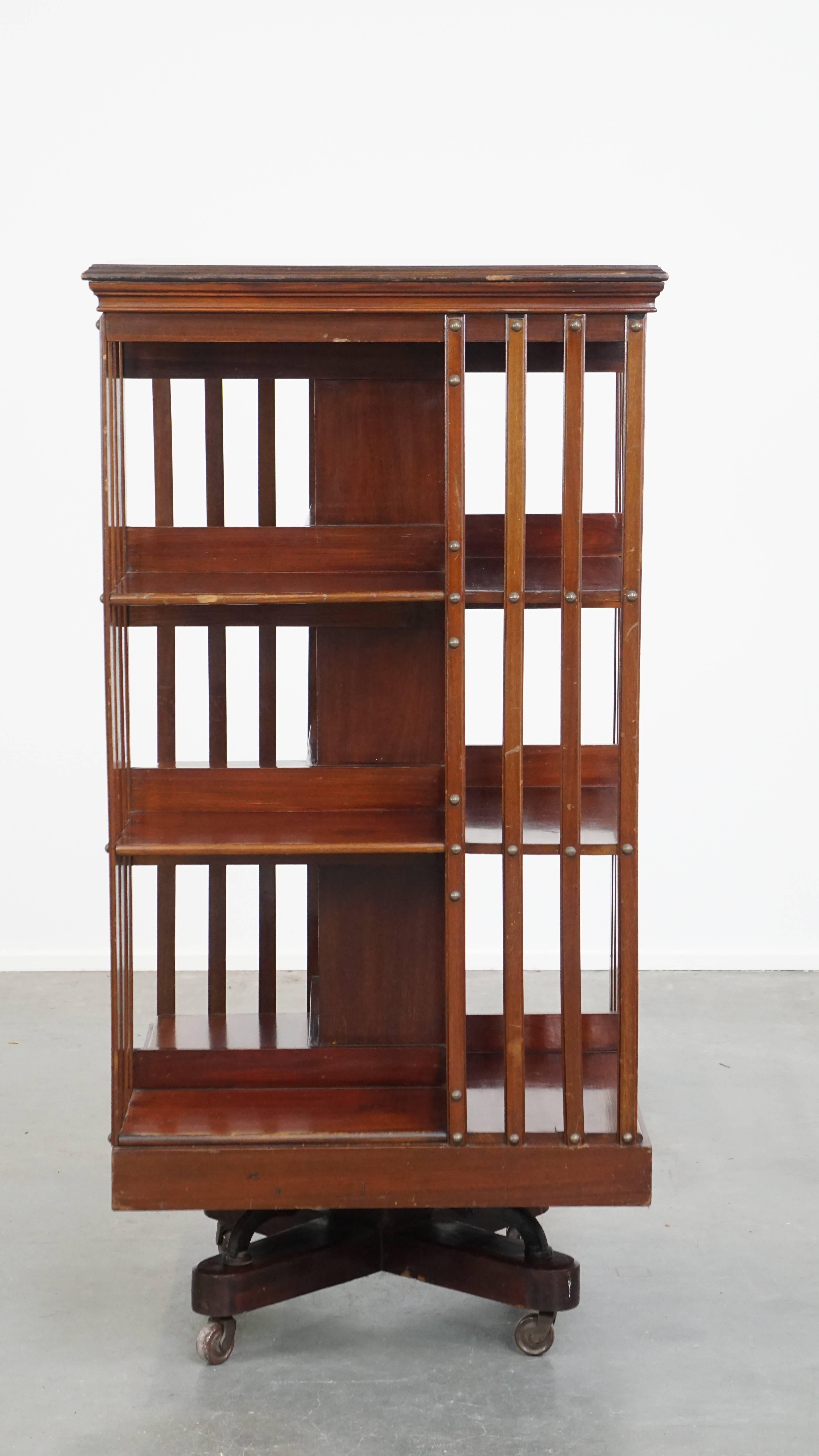 A fantastic addition for every book and interior enthusiast! This large and luxurious antique English book carousel features a cast iron base and is mounted on wheels, making it easy to move. It provides the perfect stylish space to store your books