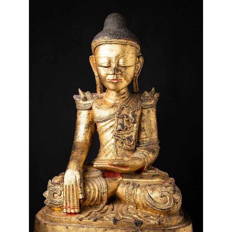 This antique wooden Buddha statue is a truly unique and special collectible piece. Standing at 91 cm high, 46 cm wide, and 35.5 cm deep, it is made of wood and it has been gilded with 24 krt gold leaf, adding to its beauty and value. The intricate