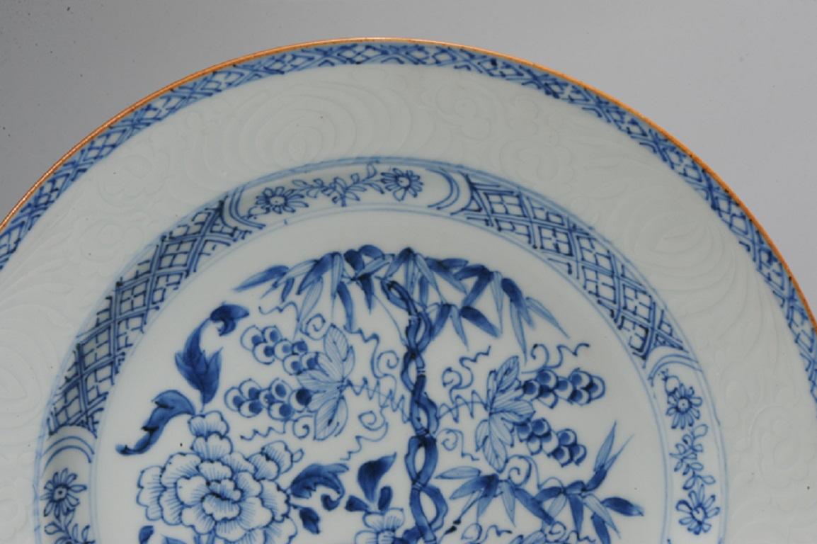 A very nicely made piece of 18th century Yongzheng period chinese porcelain with a central scene of a garden with Bamboo
The painting is of high quality and the border also has anhua (hidden) decoration of flowers.

Additional information:
Material: