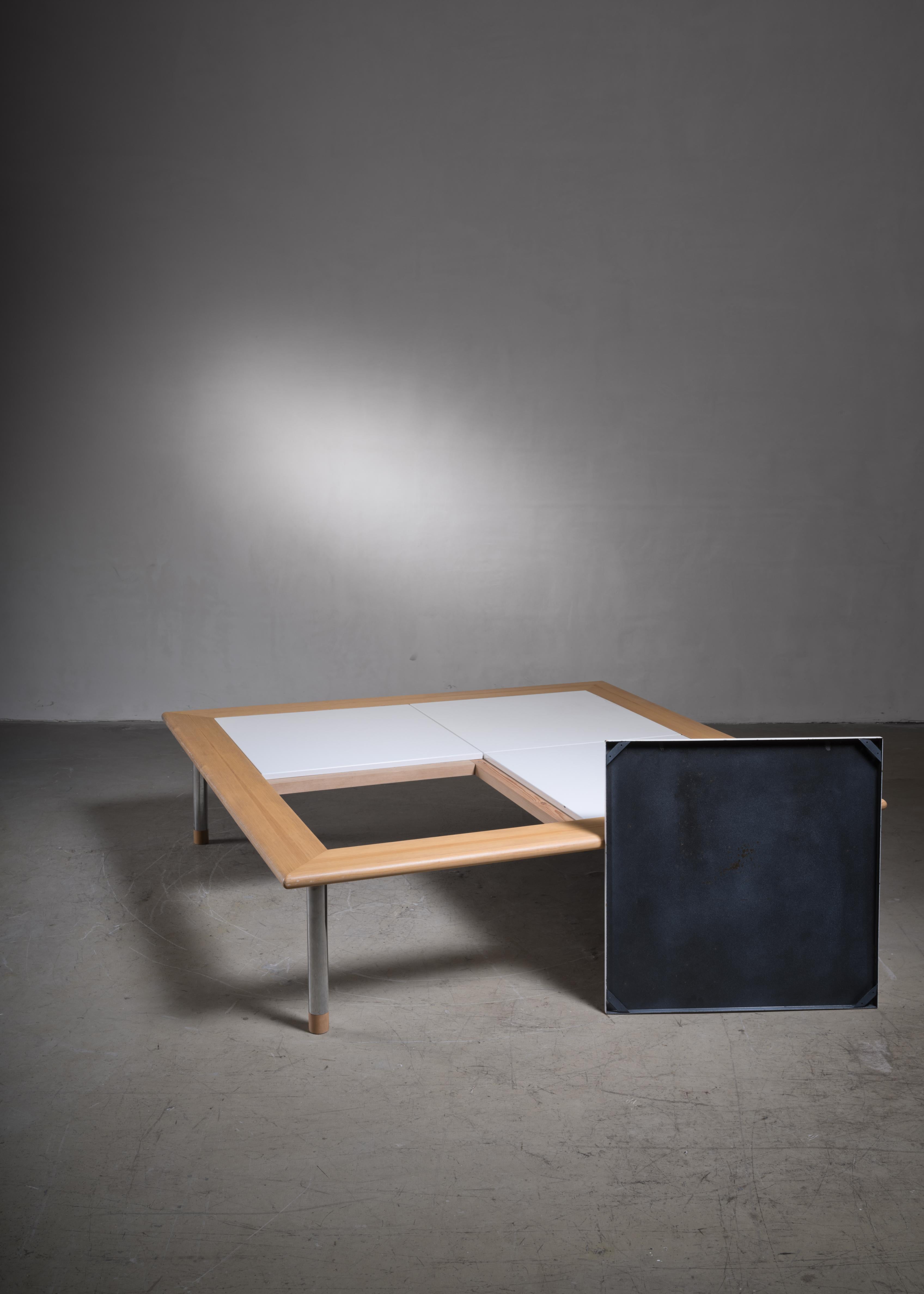A rare, square coffee table, designed in 1980 for Vuokko by Antti Nurmesniemi. The table is made of four white enameled metal plates, framed in lacquered pine wood, resting on chrome legs.

Also available in smaller size with 2 enameled metal