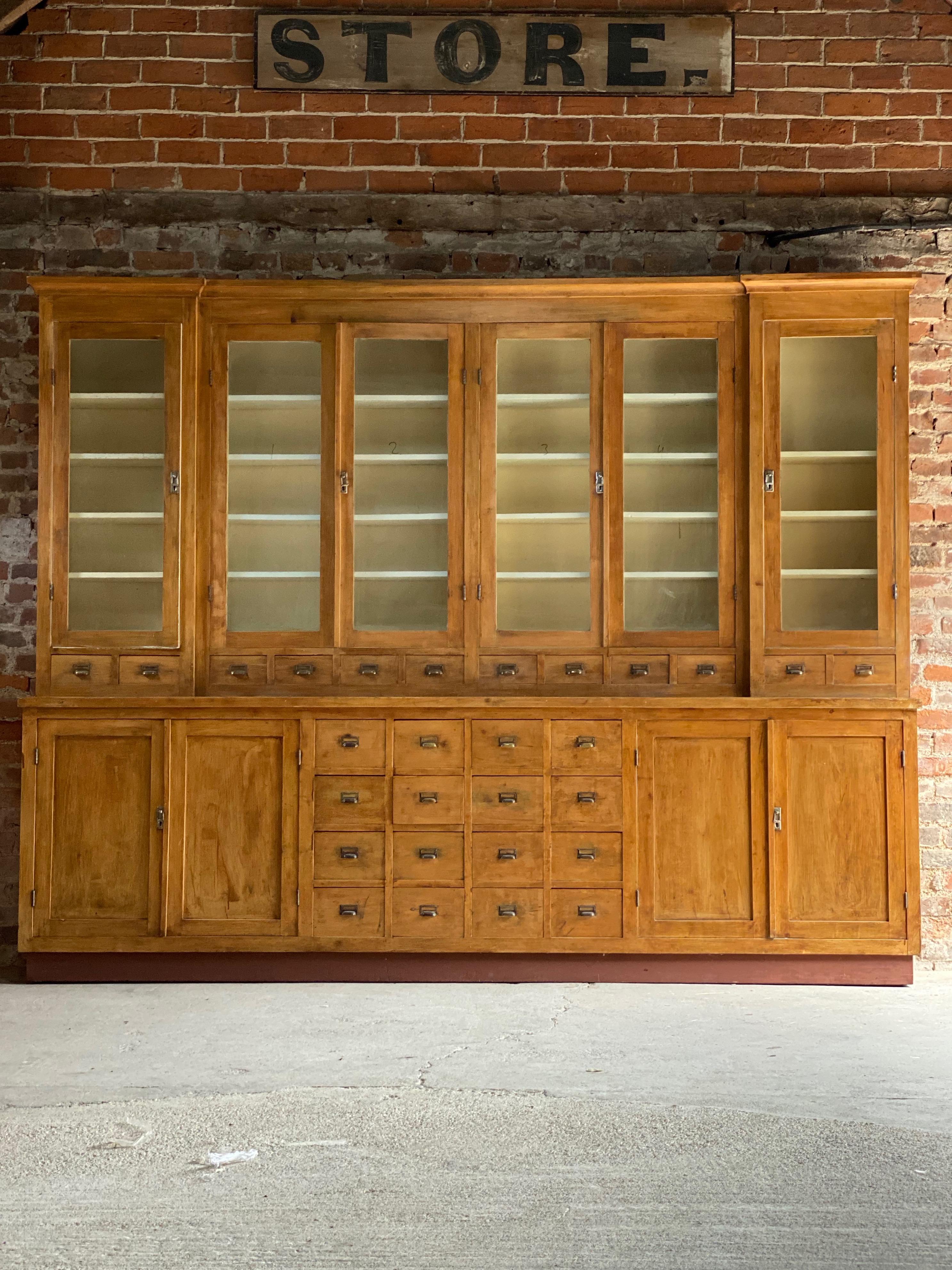 Large apothecary display cabinet pharmacy chemist shop circa 1920s number 2

Magnificent breakfront Apothecary Pharmacy beech display cabinet dating to circa 1920s, This piece is one of six similar pieces all from the same pharmacy, the upper