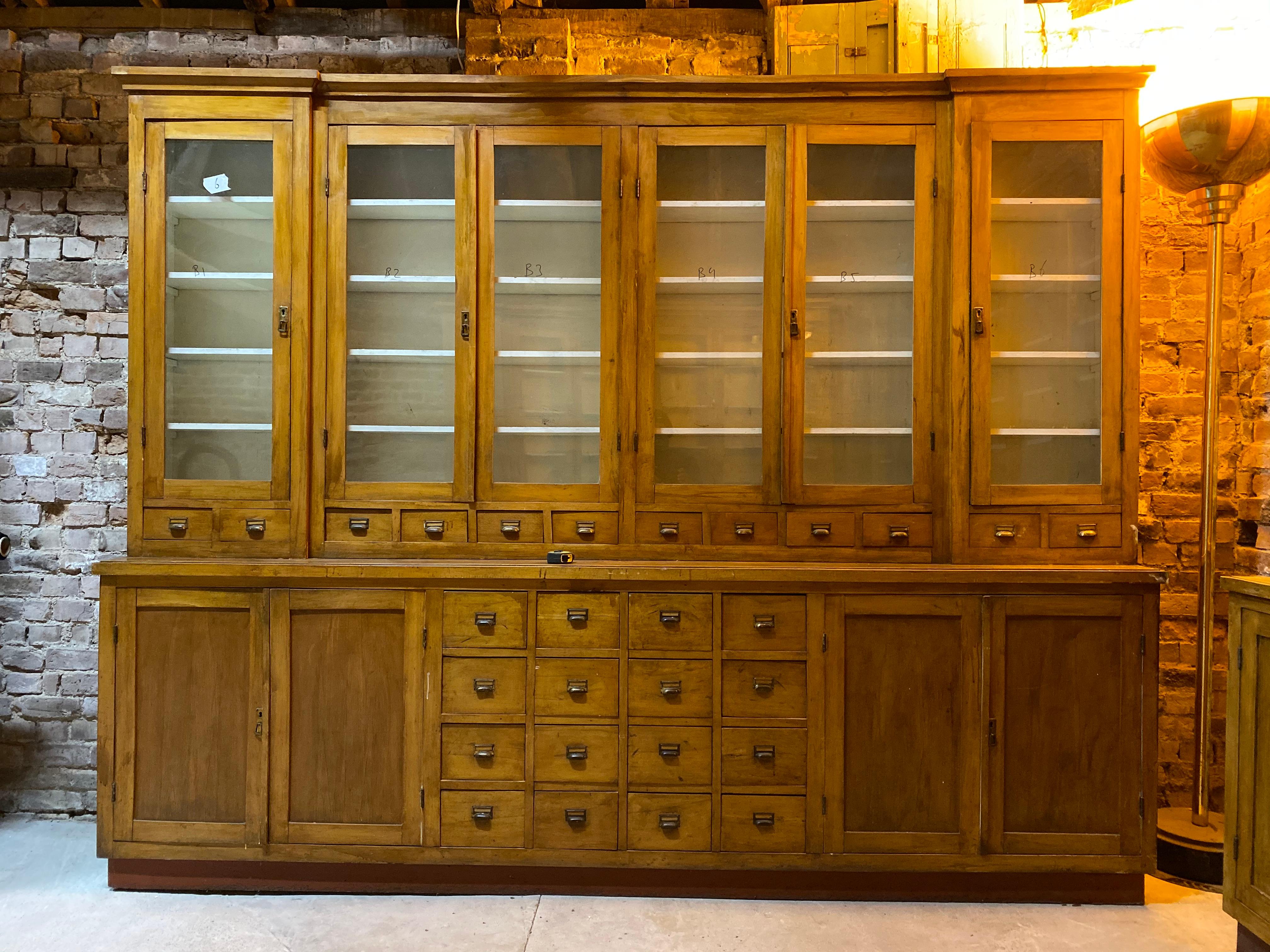 Large Apothecary Display Cabinet Pharmacy Chemist Shop Circa 1920s Number 3

Magnificent breakfront Apothecary Pharmacy beech display cabinet dating to circa 1920s, This piece is one of six similar pieces all from the same pharmacy, the upper