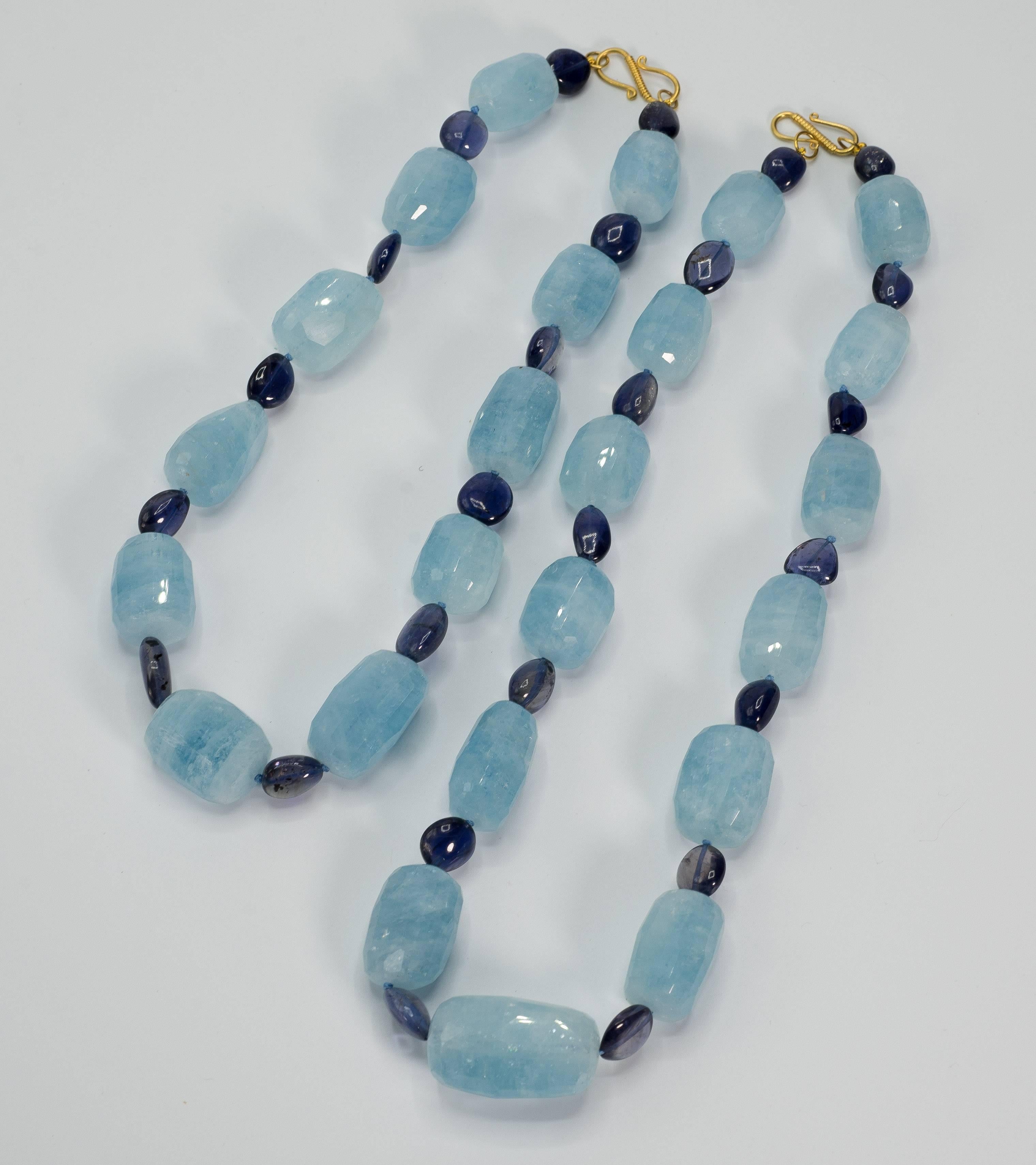 Wonderful, versatile and wearable double separable large Aquamarine and navy blue Kyanite gold clasp necklaces. May be worn as a pair or singly, each necklace nests for double wear, one measures 17'' and the other 20''.  Approximate weight of