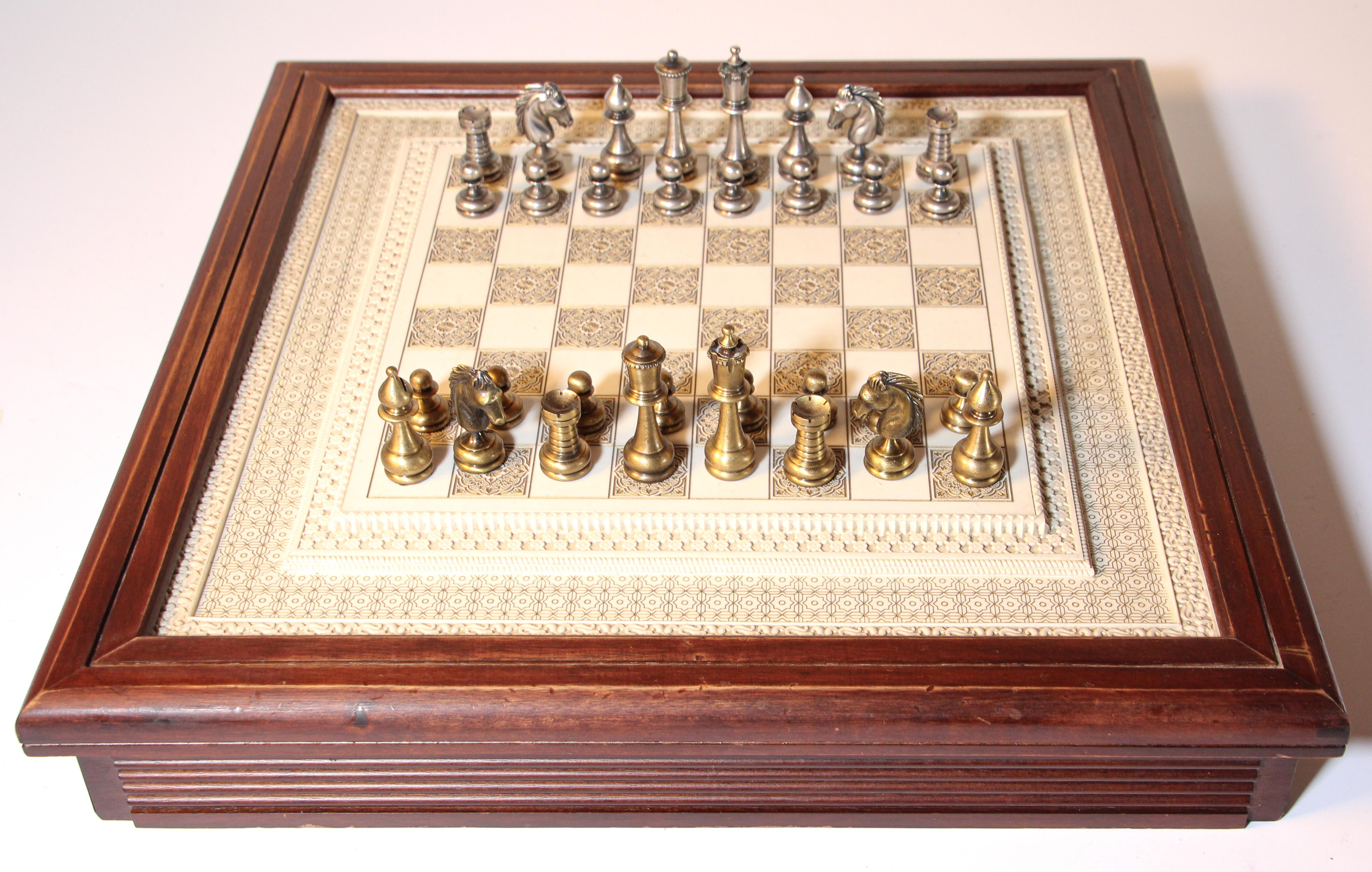 Large Arabesque Firenze Florence Italian game chess set with elaborately carved board in Moorish style with brass and nickel plated Firenze chess pieces.
Each Metal silver and gold finish piece is felted in the bottom and marked 