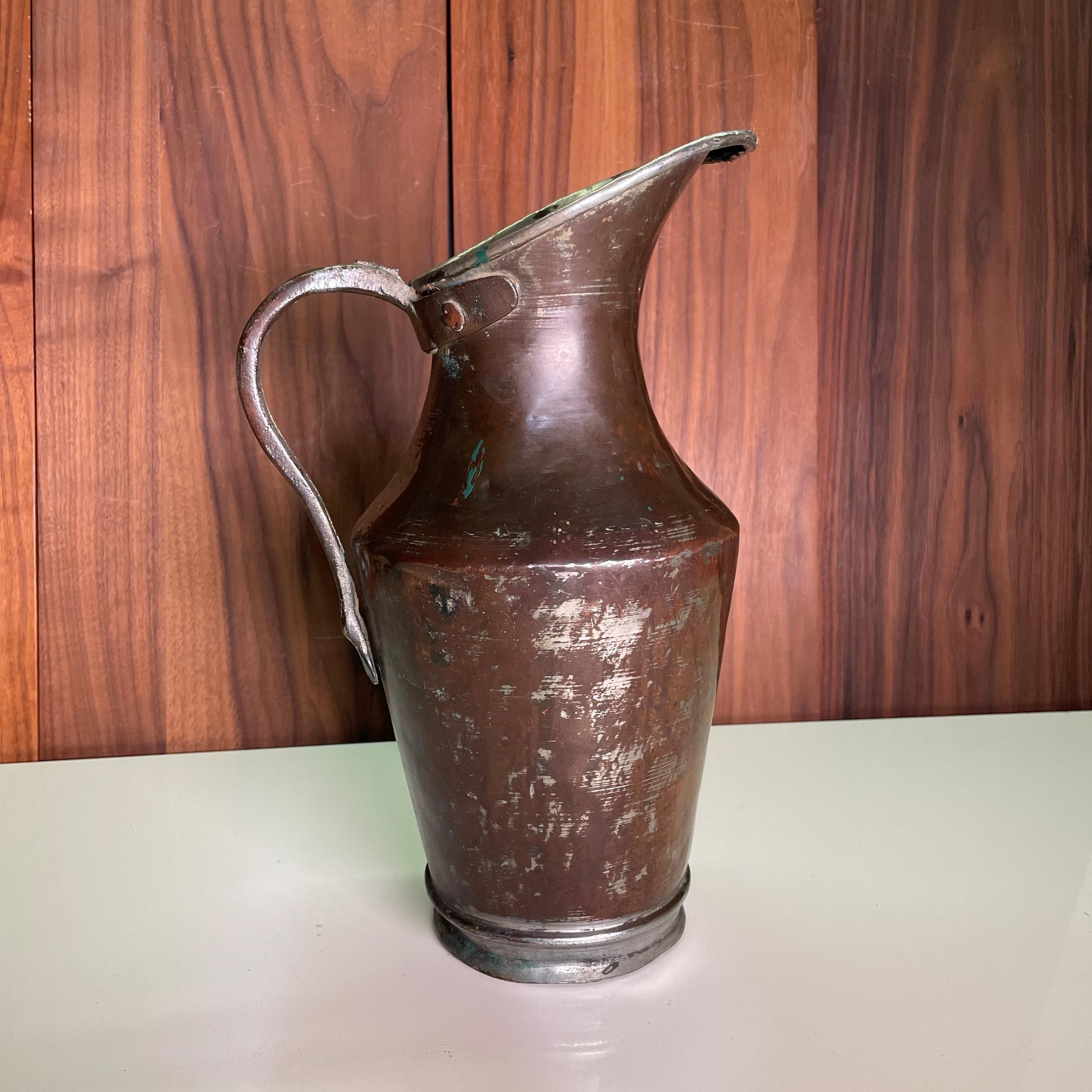antique metal water pitcher