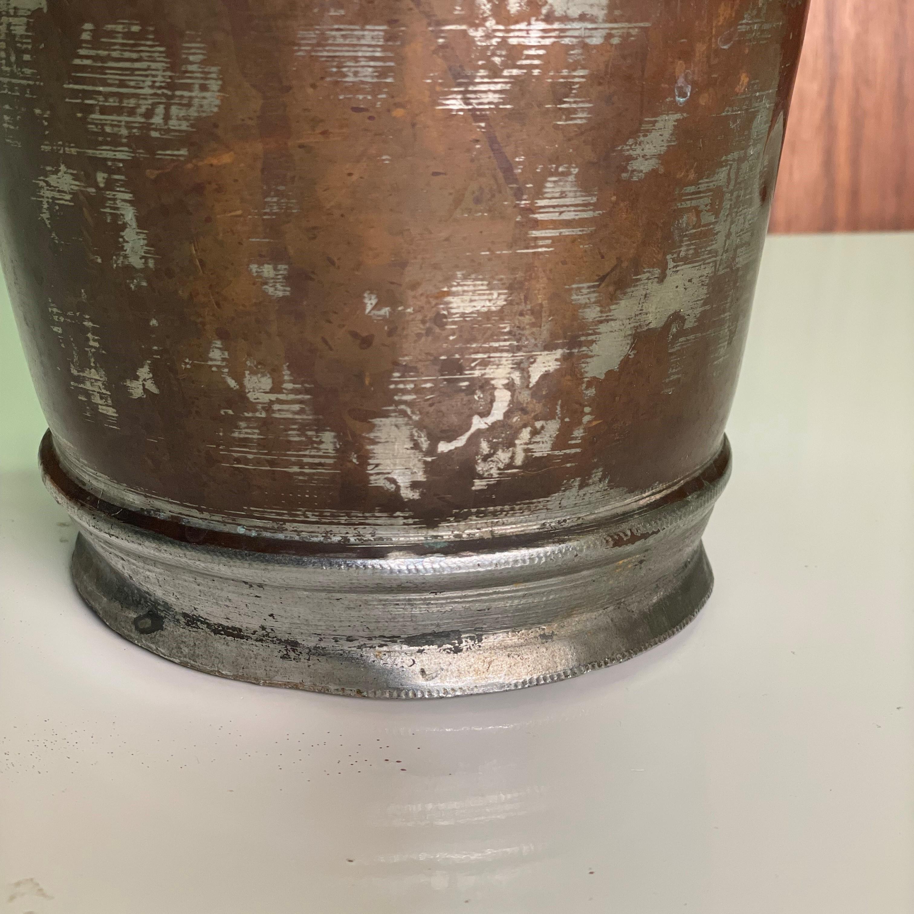 antique metal water pitcher