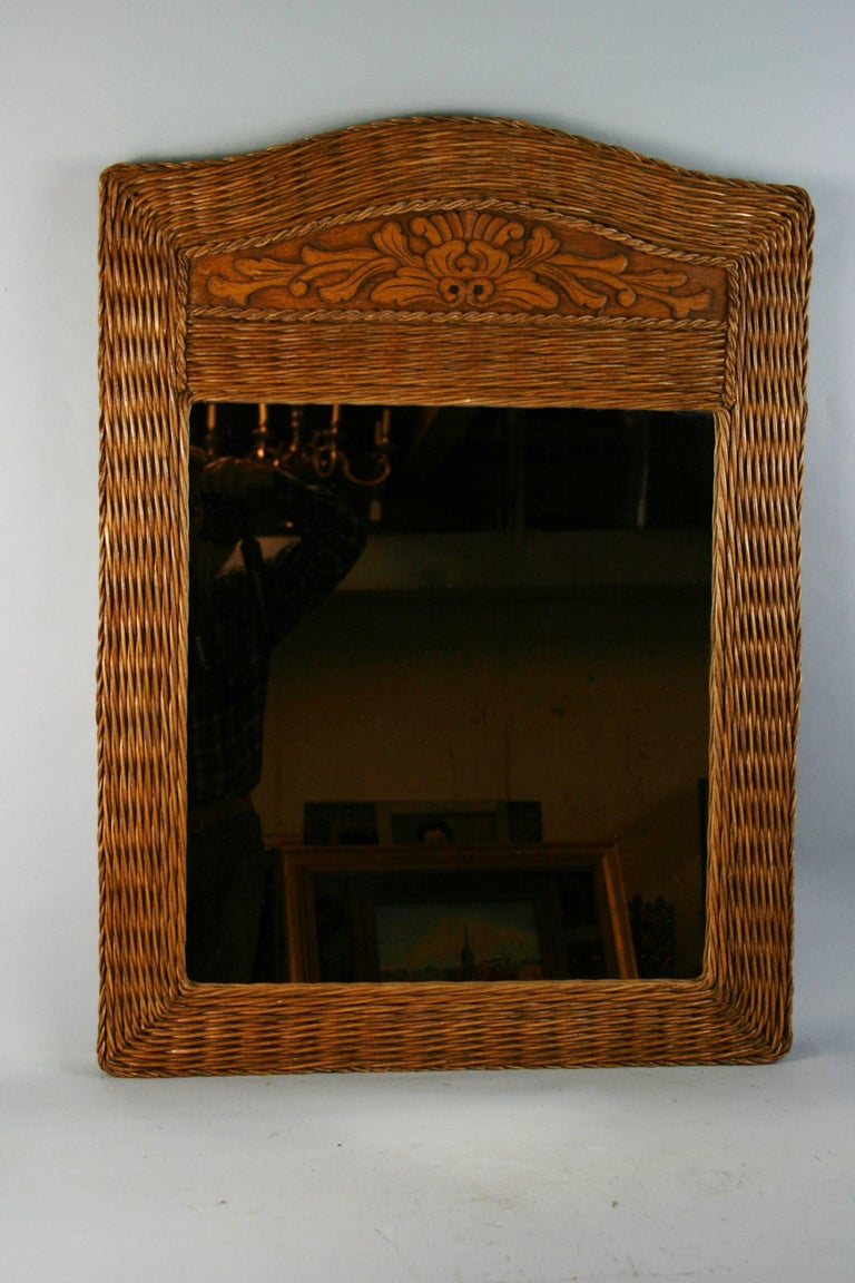 Large rattan mirror with carved wood insert.