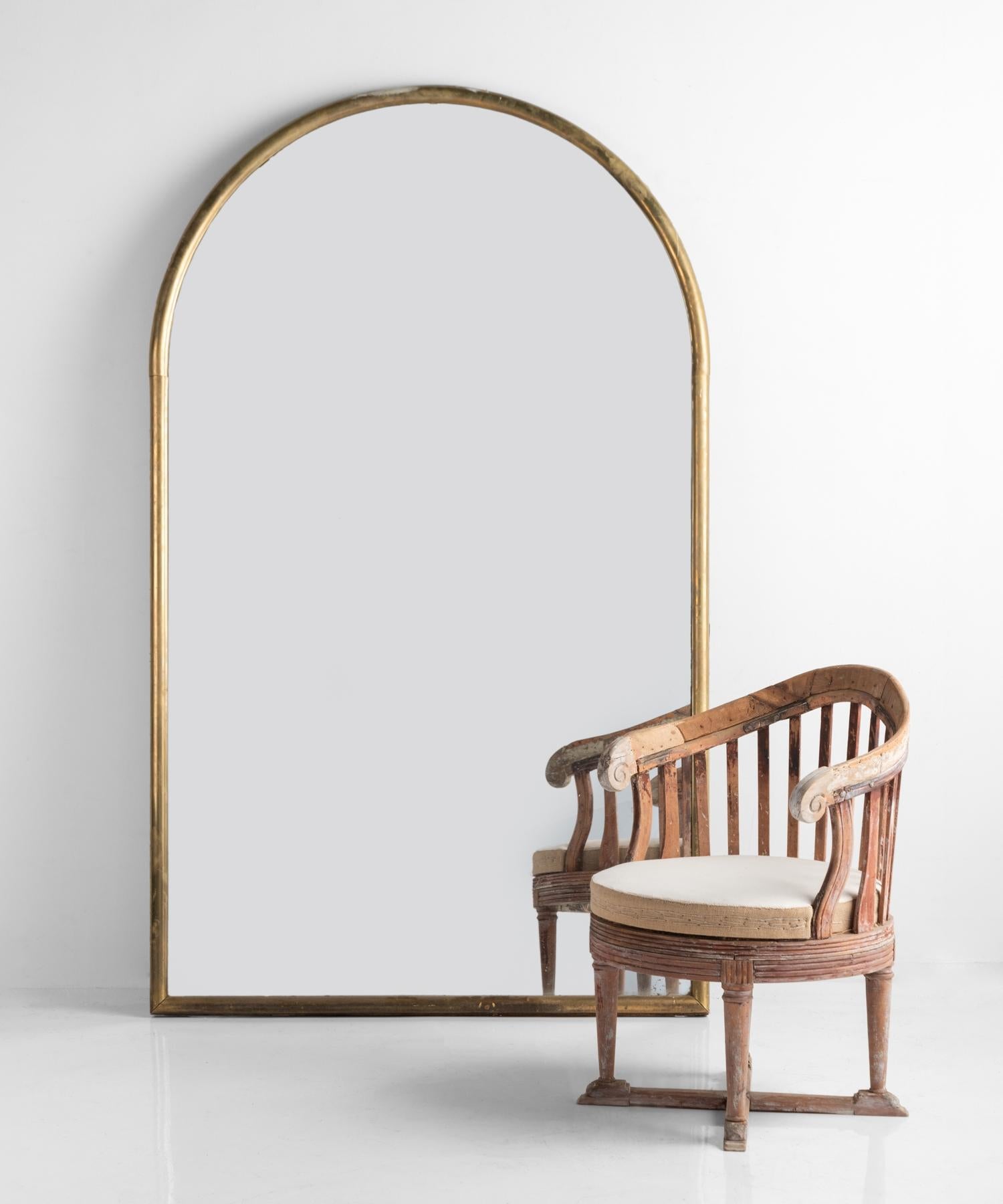 Large arched brass mirror, France circa 1930.

Uniquely large, substantial brass framed mirror with elegant arch top.

            