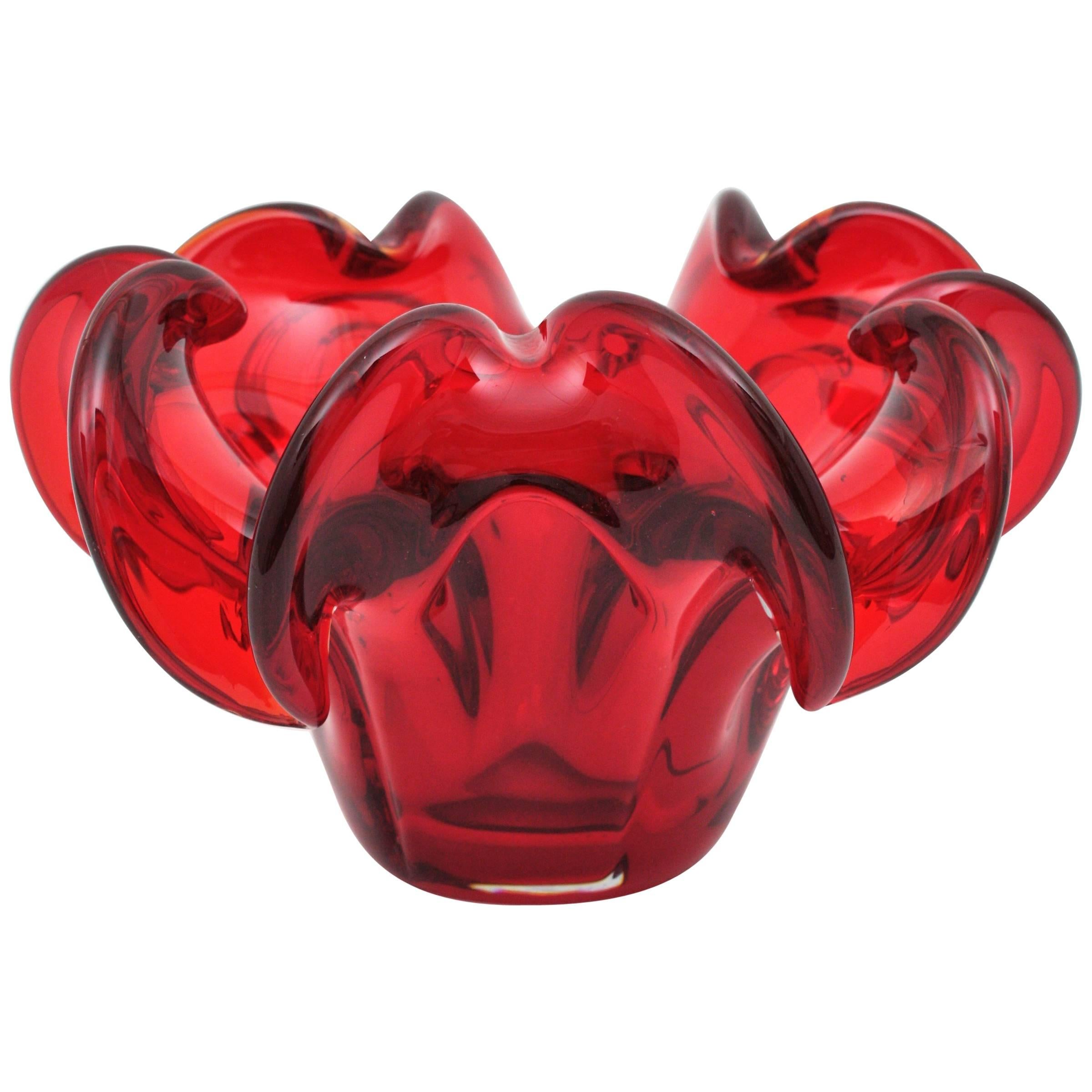Large hand blown Murano ruby red glass flower centerpiece or bowl. Attributed to Archimede Seguso, Italy, 1950s.
This eye-catching bowl is made of hand blown red glass cased into clear glass using the Sommerso technique.
Lovely to be used as