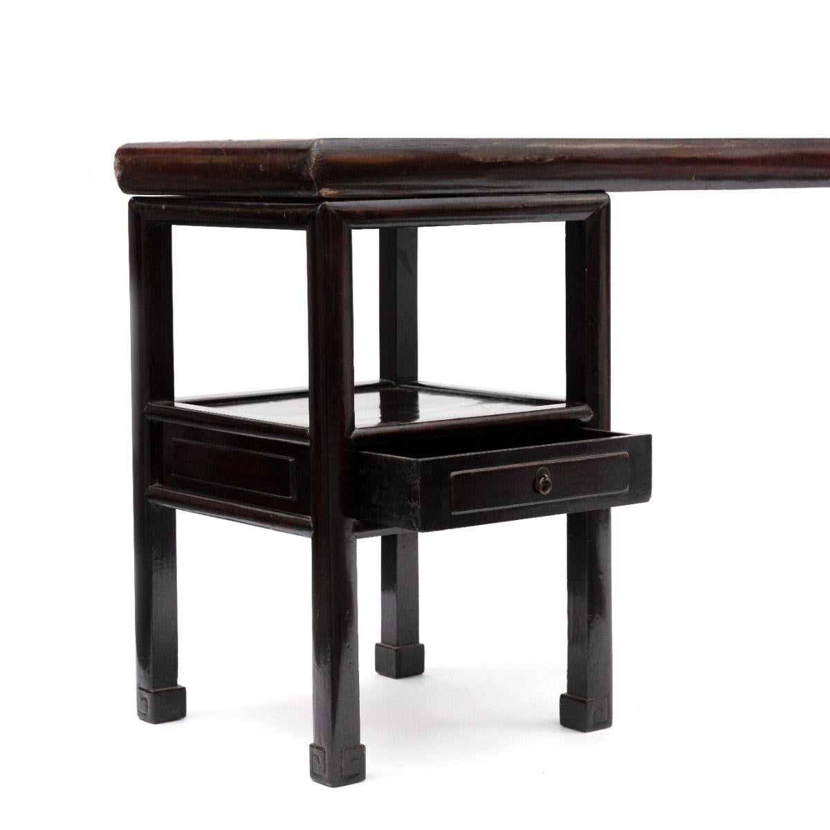 Monumental architectural console table from the Qing period, c. 1840. The table is believed to be unique.
Original Burgundy lacquer with a beautiful natural patina.

The table is in three parts which allows you to place the tabletop as preferred on