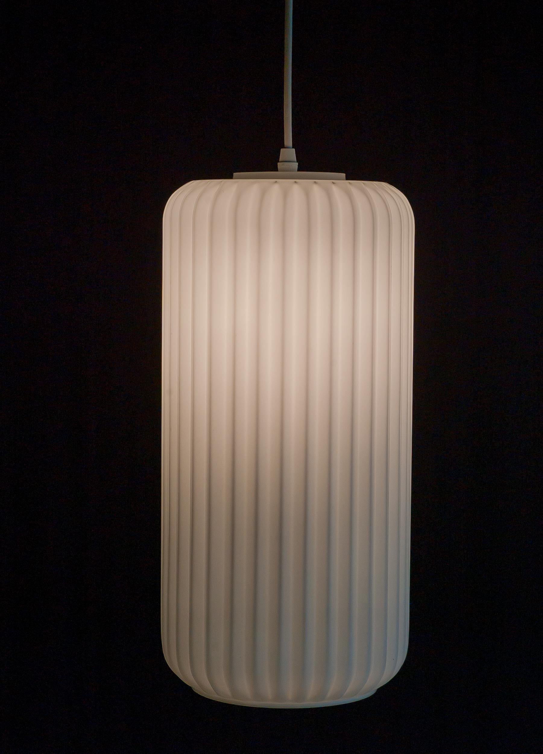 Wonderful Minimalist large 1950s ribbed opaline glass pendant with white enameled brass hardware.
Identical glass shades are used on several 1950s Angelo Lelli for Arredoluce floor lamps. 
The lamp is unmarked. We have 3 of these pendants, priced