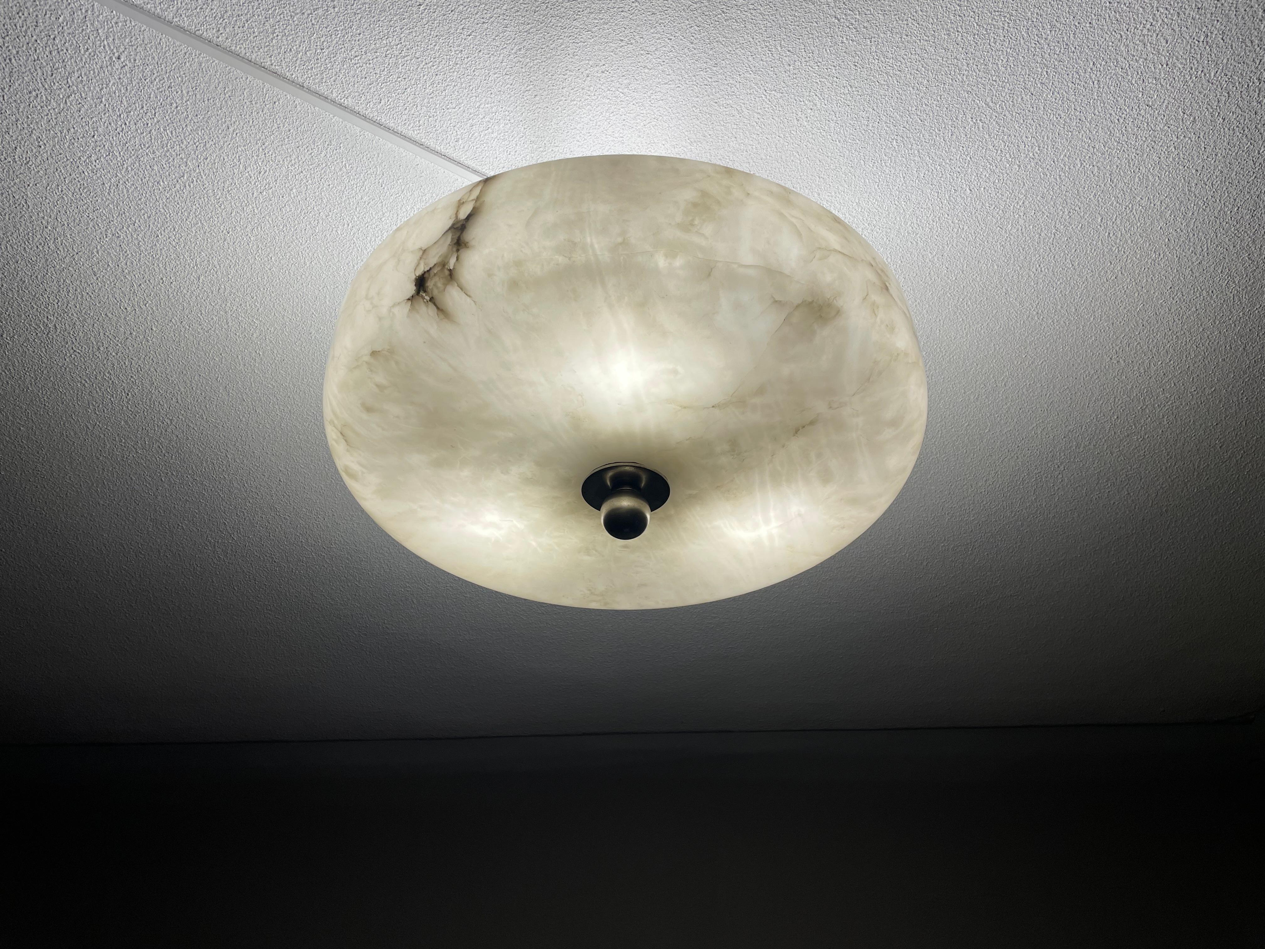 Unique and large, three light alabaster flush mount.

This unique Art Deco fixture from the heydays of the European Art Deco era will light up both your days and evenings. Its striking and geometrically rounded design shade with the high edge and