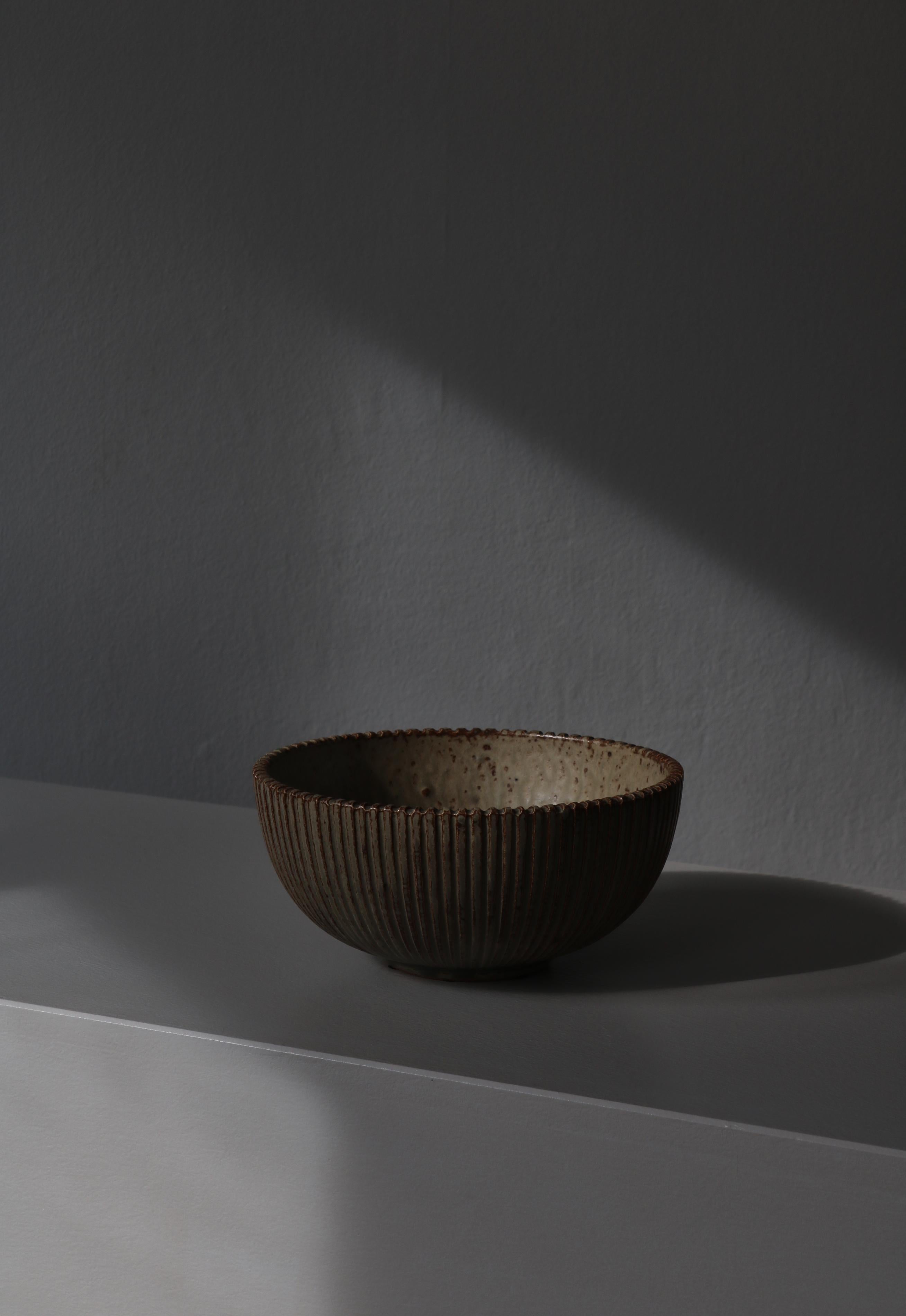 Fluted stoneware bowl with beautiful grey-greenish glaze made by Danish artist Arne Bang at his own studio in Copenhagen the 1930s. Signed with monogram 