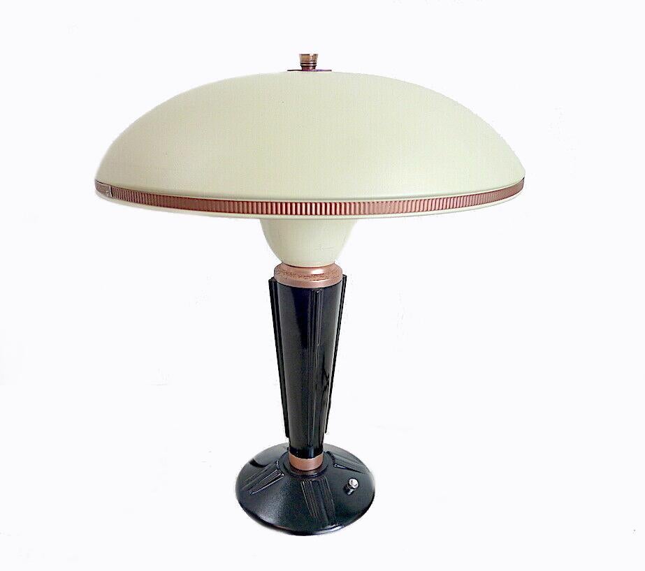 Designed by Eileen Gray for the French Jumo company and dating to the 1930s this very stylish lamp is made from two primary components which are bakelite and metal. Superb mushroom shape enameled metal shade with copper accents and finial. Condition