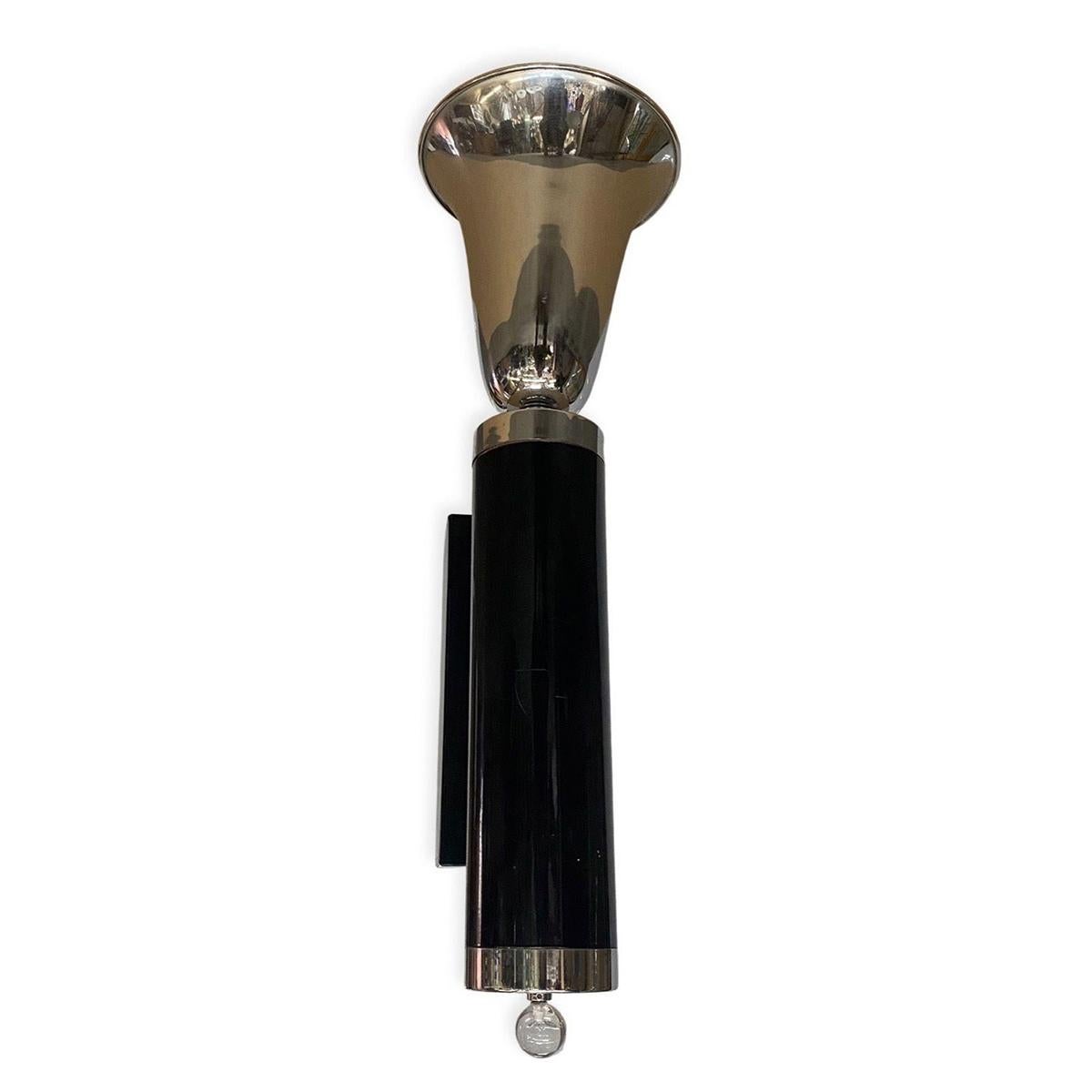 1930s elegant design champagne-shaped torchiere top with black enameled fluted column center. The end of the base has a lucite glass ball. 

5-Available

The dimensions of each sconce are:
Height 29