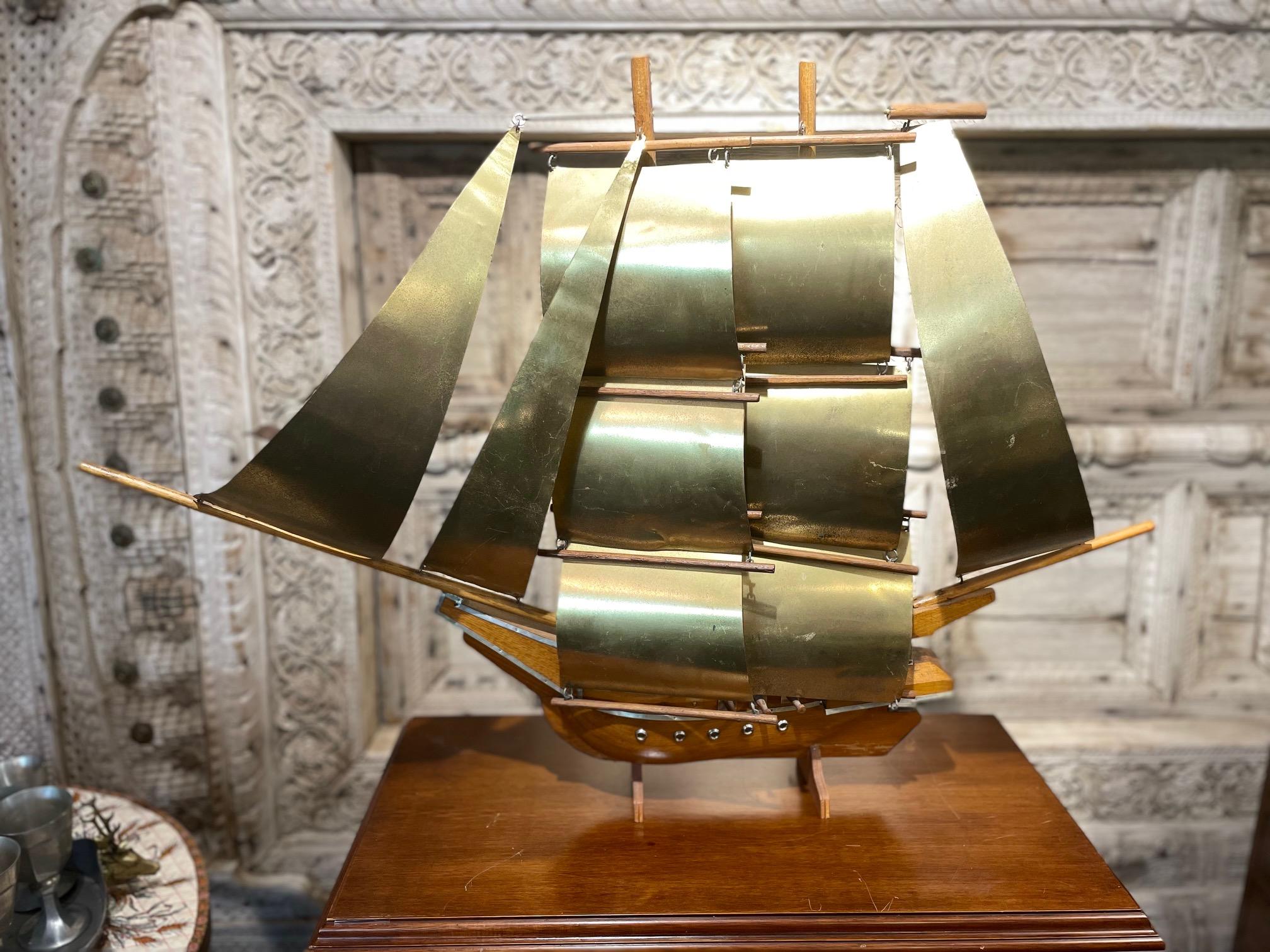 Artisanal boat sculpture with wood boat hull and brass sails in original vintage condition, nice patina. 
This piece is unusual by its size, highly decorative!
Missing one cannon behind the front sails.
   