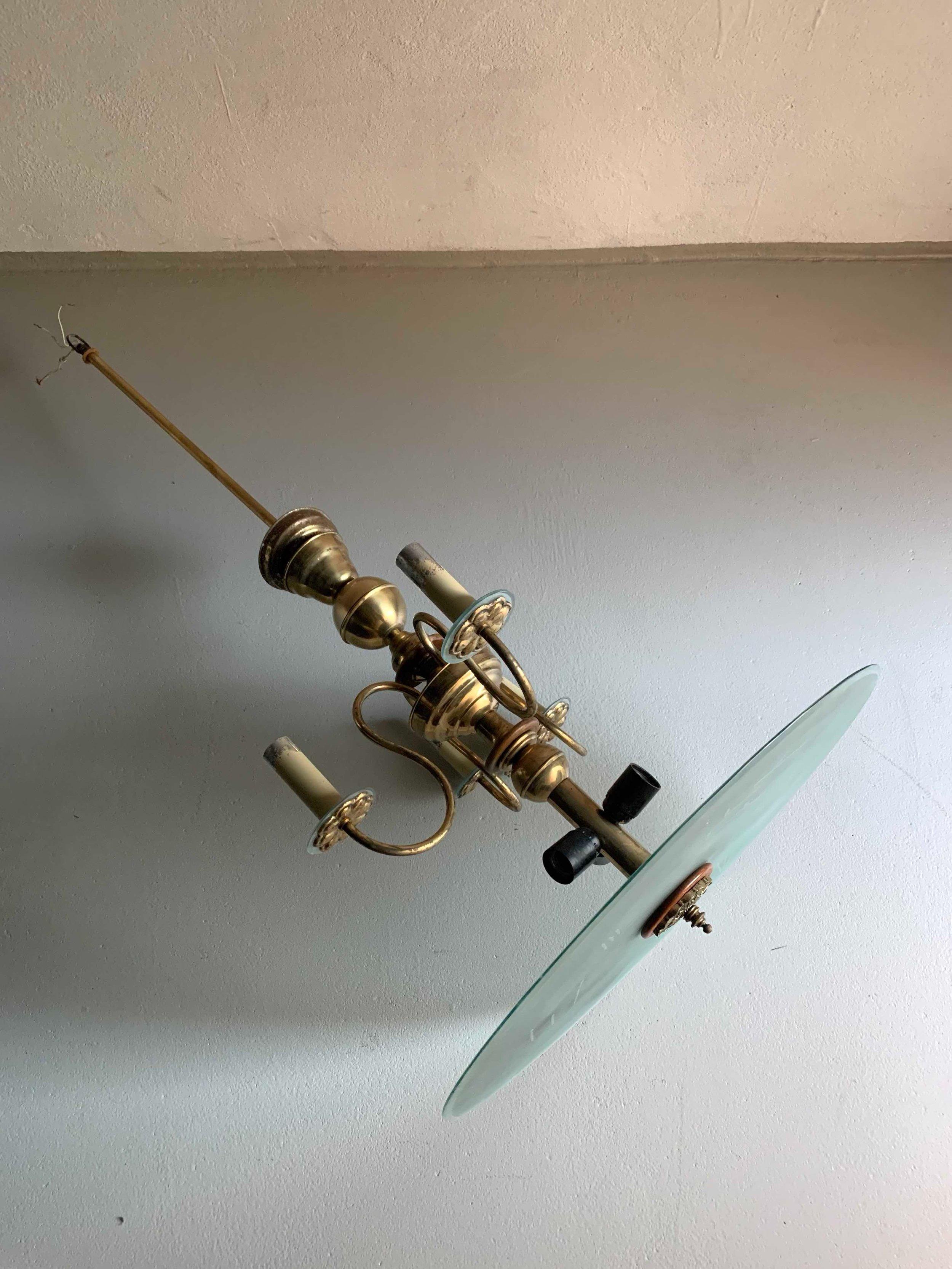 Large Art deco chandelier - brass and oak details, frosted glass plate-shade.

Additional information:
Country of manufacture: Germany
Design period: 1930s
Dimensions: 60 D x 107 H cm 
Condition: Good vintage condition with some signs of use on a