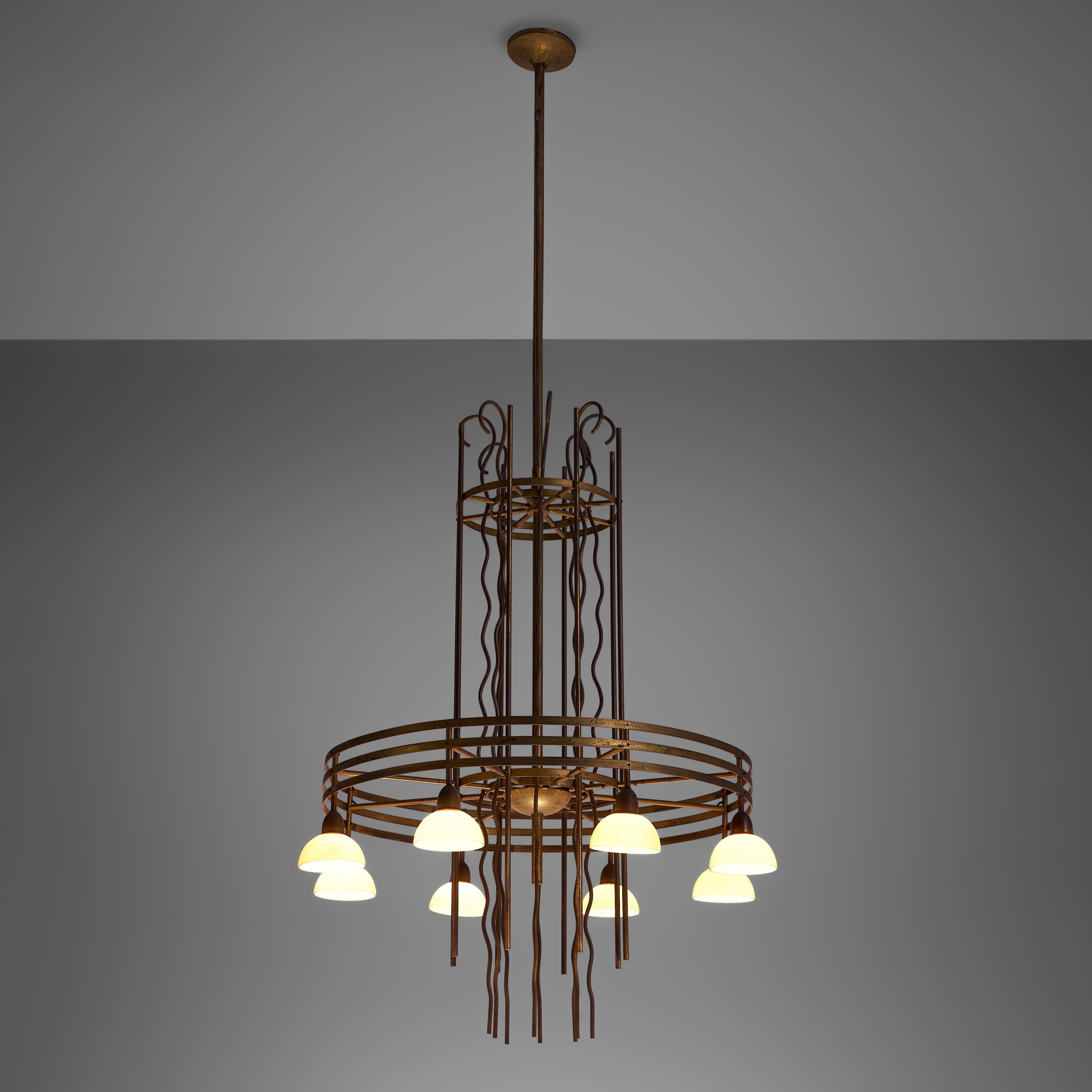 Art Deco chandelier, brass, glass, Sweden, 1930s.

Highly detailed brass chandelier from Sweden, made in the 1930s. This chandelier features two layers of multiple brass rings and organic shaped brass strings in between. The first layer contains one
