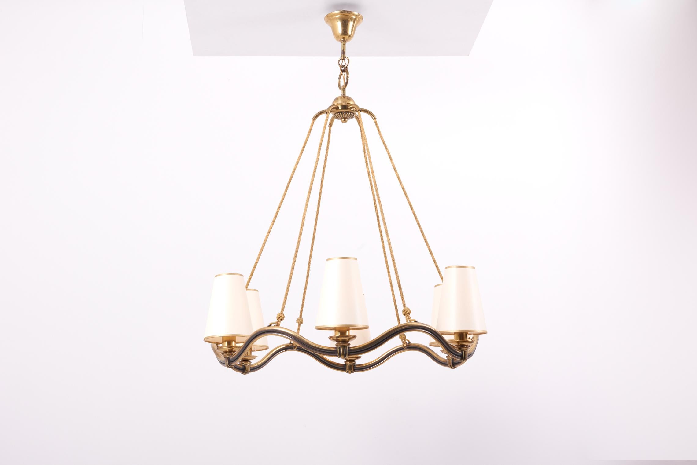 1930s Art Deco chandelier by Hugo Gorge, Austria.
Made of brass and including new custom lamp shades in cream chintz with golden paper edge.

6 x E27 sockets.

Please note: Lamp should be fitted professionally in accordance to local