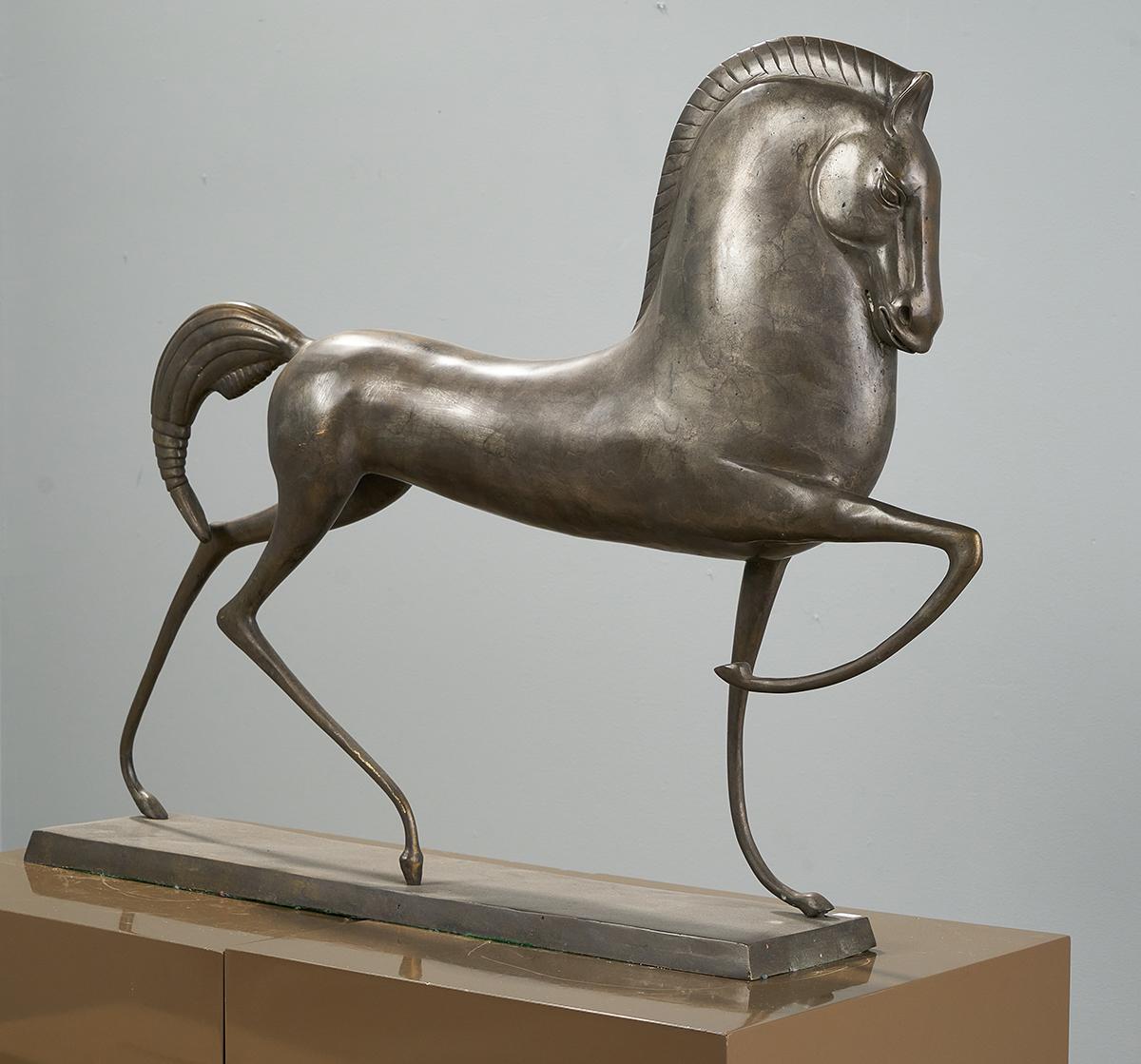Large Deco Style Etruscan Horse Sculpture in the Style of Boris Lovet-Lorski.

A striking bronze sculpture of a horse, showcasing elegant deco-influenced lines, perched on a bronze rectangular base.