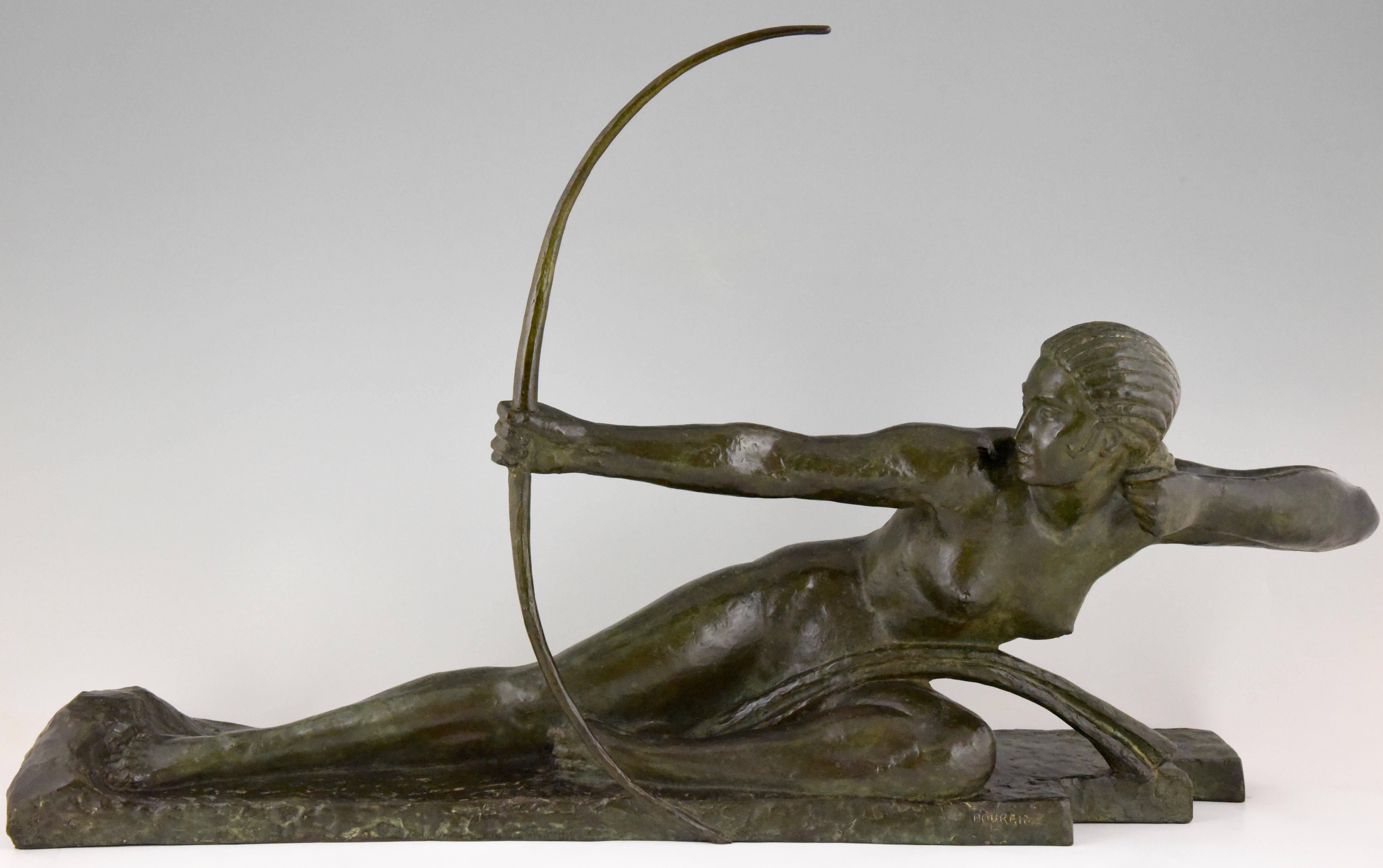 Impressive Art Deco bronze sculpture of a nude with bow picturing Penthesilia, queen of the Amazons. Signed by the famous French sculptor Marcel André Bouraine 1886-1948. Beautiful dark green patina.
This spectacular sculpture has the Susse Freres