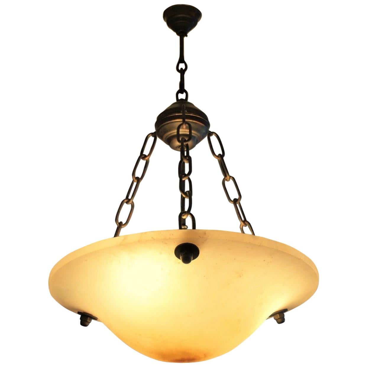 Midcentury large Art Deco carved alabaster and burnished brass chandelier with solid iron chains, in the centre three E27 light bulb holders.

Measures:
Height 29.50 in (75 cm)
Diameter 20 in (50.5 cm).

 