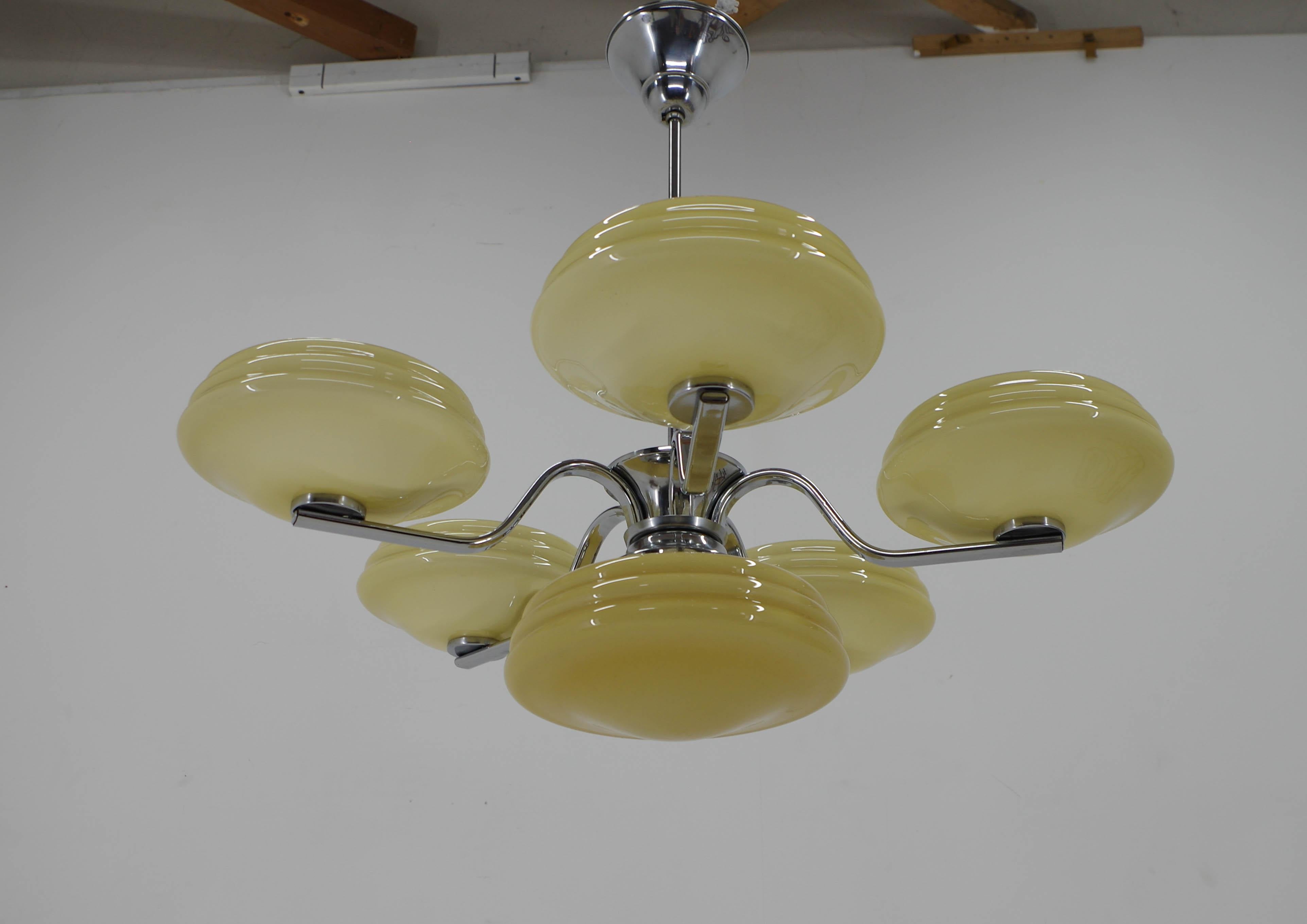 Art Deco chandelier made in 1940s in Czechoslovakia.
Restored, cleaned, polished
Rewired: two separate circuits - 1+5x60W, E25-E27 bulbs
US wiring compatible