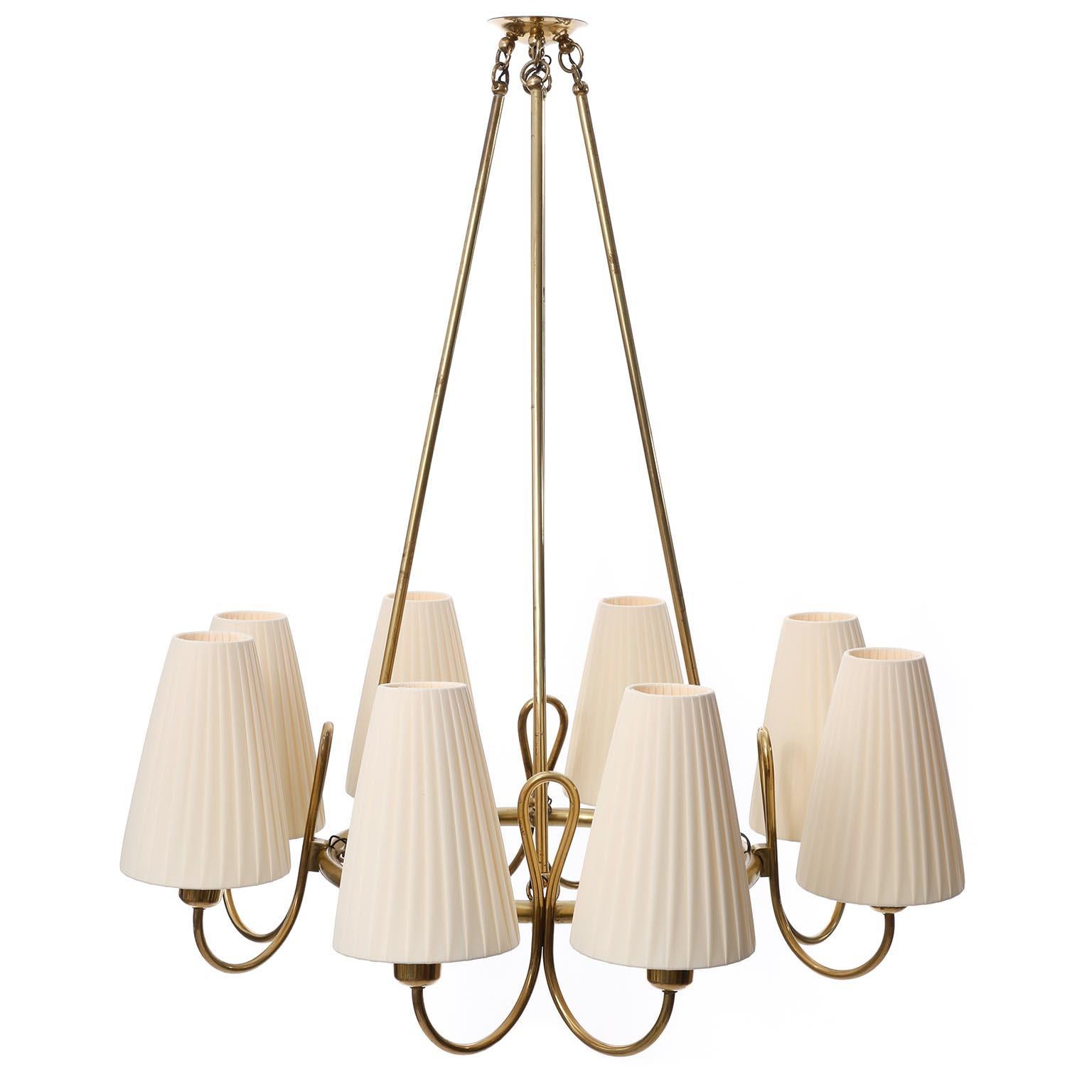 A fantastic chandelier made of brass with cream colored pleated fabric shades attributed to Josef Frank, manufactured in Austria in 1930s.
The brass parts are in very good original condition with patina and have a warm aged hue.
The lamp shades are