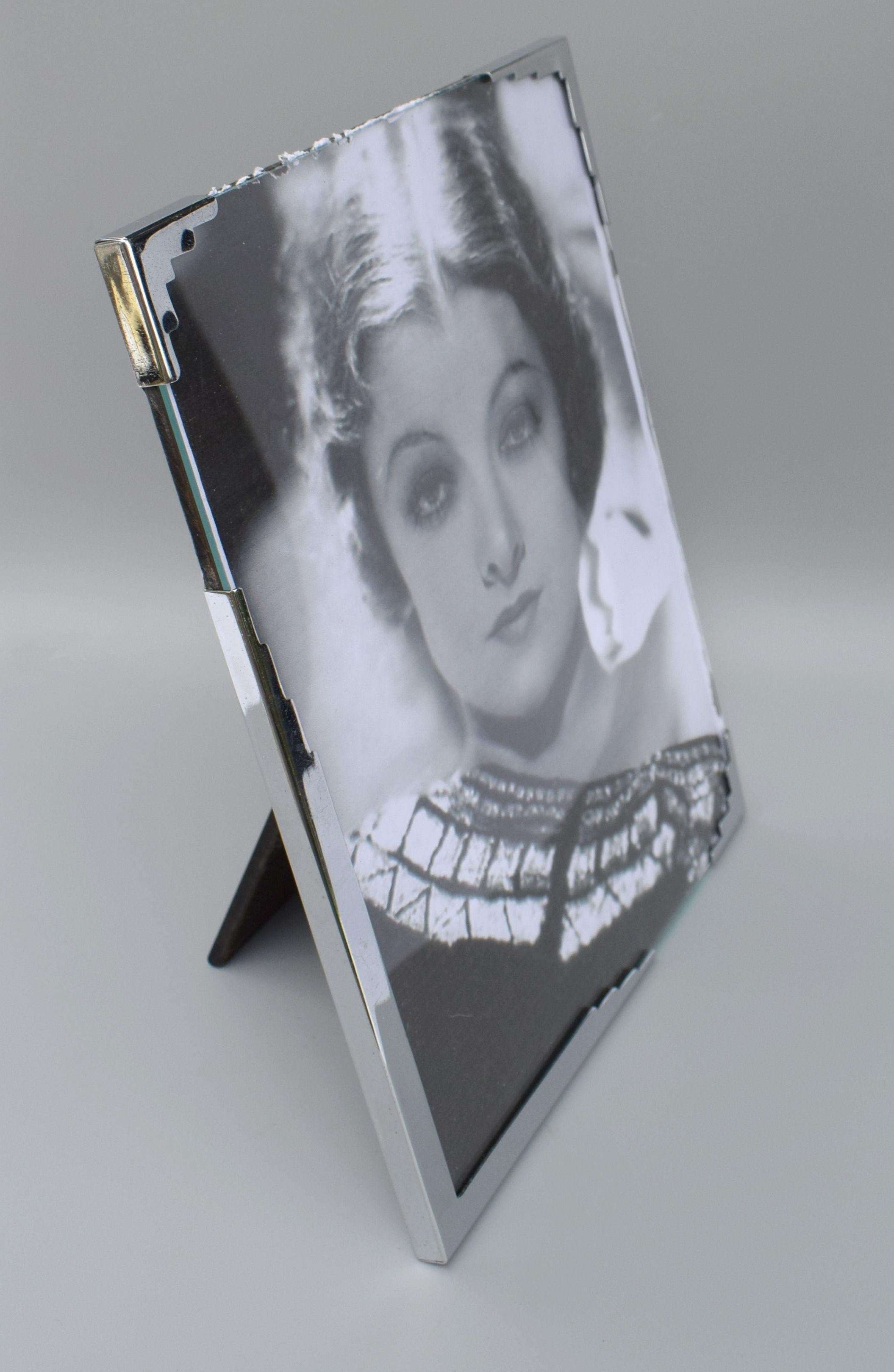Very stylish and totally original 1930s Art Deco chrome picture frame, totally authentic and in great condition. Free standing with hardboard backing and glass front. A real must for any Art Deco admirer! Marked to the back ' Made In England' with