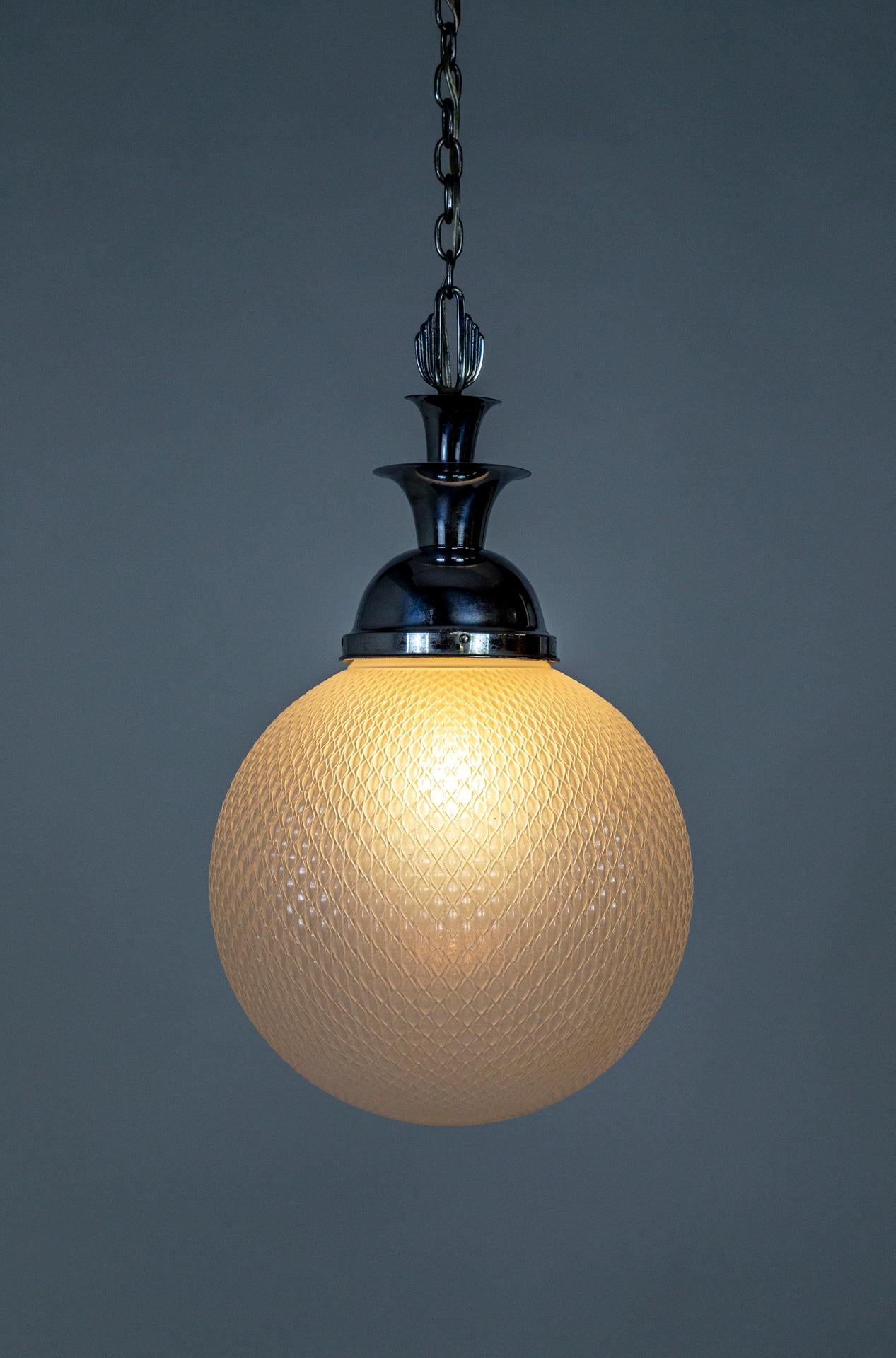 A large, hanging light fixture from the Art Deco era with a trumpeting, chrome shade holder in the iconic style. The opaline glass globe has a lovely texture with beautiful light diffusion. Original, steel hardware. Newly rewired. One medium base