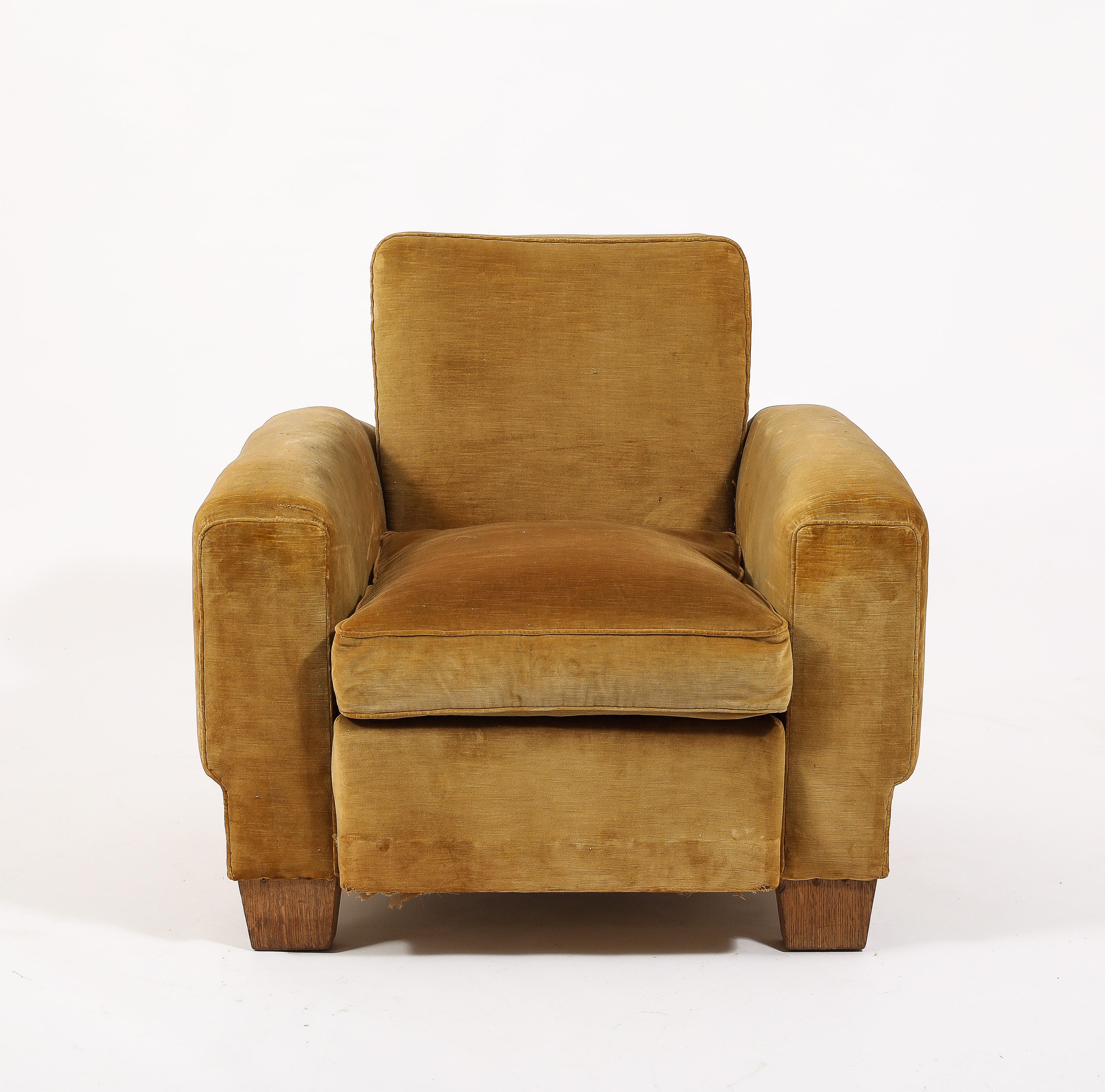 Handsome Armchair in its original upholstery and finish, large arms with a cubist flair ending in a reduced base with large oak feet.
