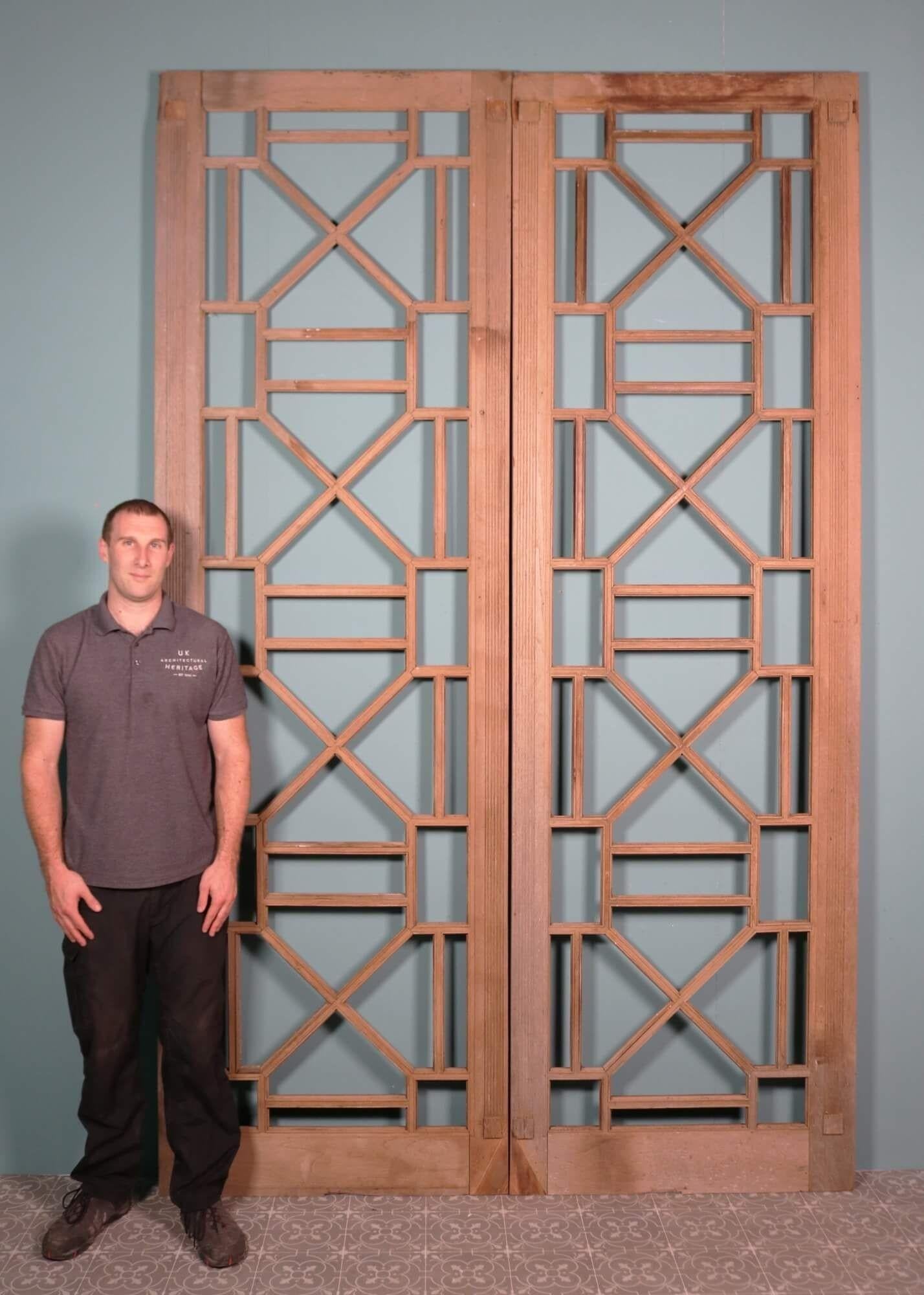 This set of tall mahogany Art Deco double doors were originally a pair of fixed panels either side of an entranceway. Unglazed, they date from the 1930s at the height of the Art Deco era and showcase a striking geometric design evocative of iconic