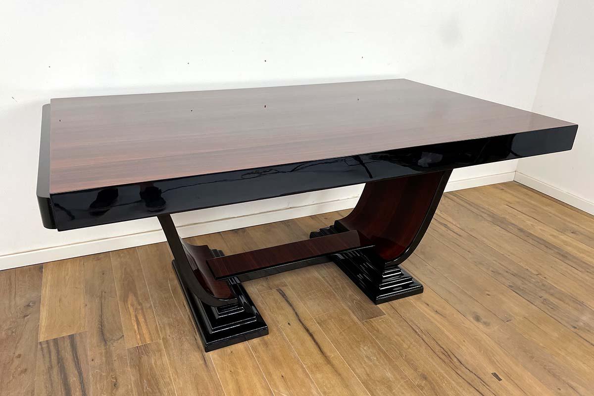 This large Art Deco table comes from Paris and was made around 1930 with great craftsmanship. The noble materials have been perfectly processed and are in very good condition. This shape of the legs and feet is extremely rare, a gondola table with