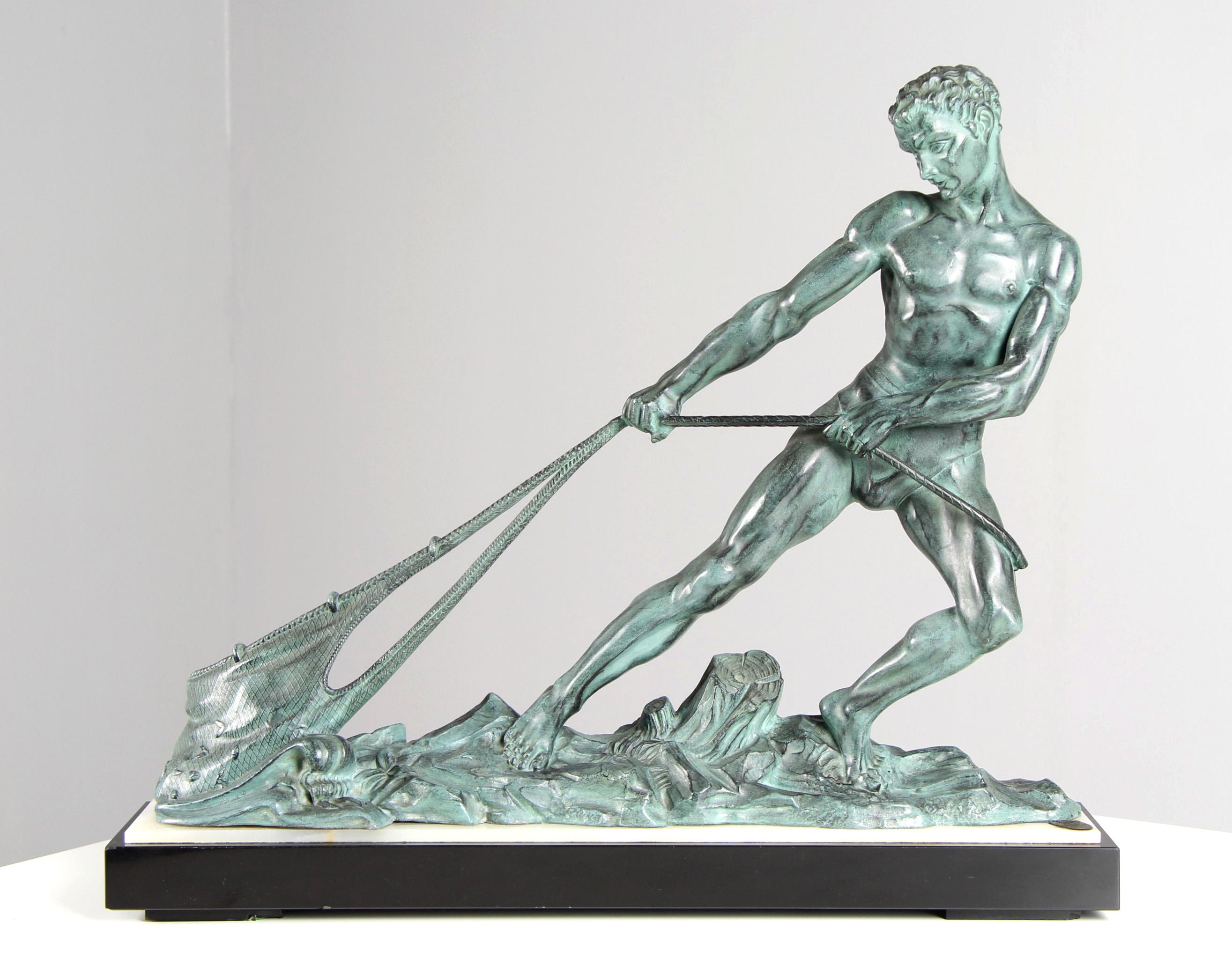 Dimensions: H x W x D: 55 x 65 x 16 cm

Description:
Large depiction of a fisherman hauling in a filled net.
The cast metal figure rests on a slab of black marble and white onyx. A young man dressed only in a loincloth stands in a tense pose on a