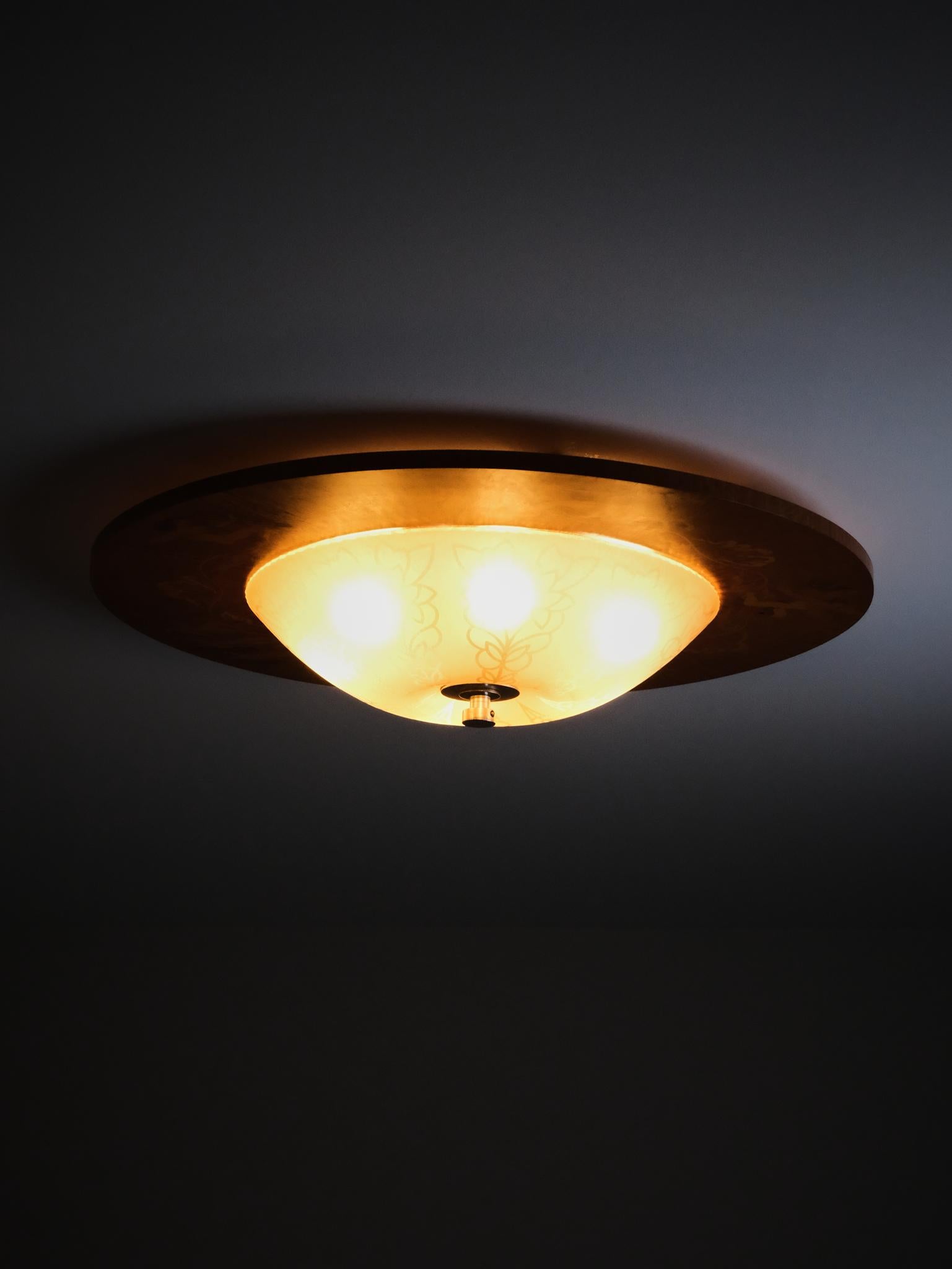 Impressive flush mount ceiling lamp designed by Birger Ekman for Mjölby Intarsia during the 1930s. 

Lovely wood inlays.