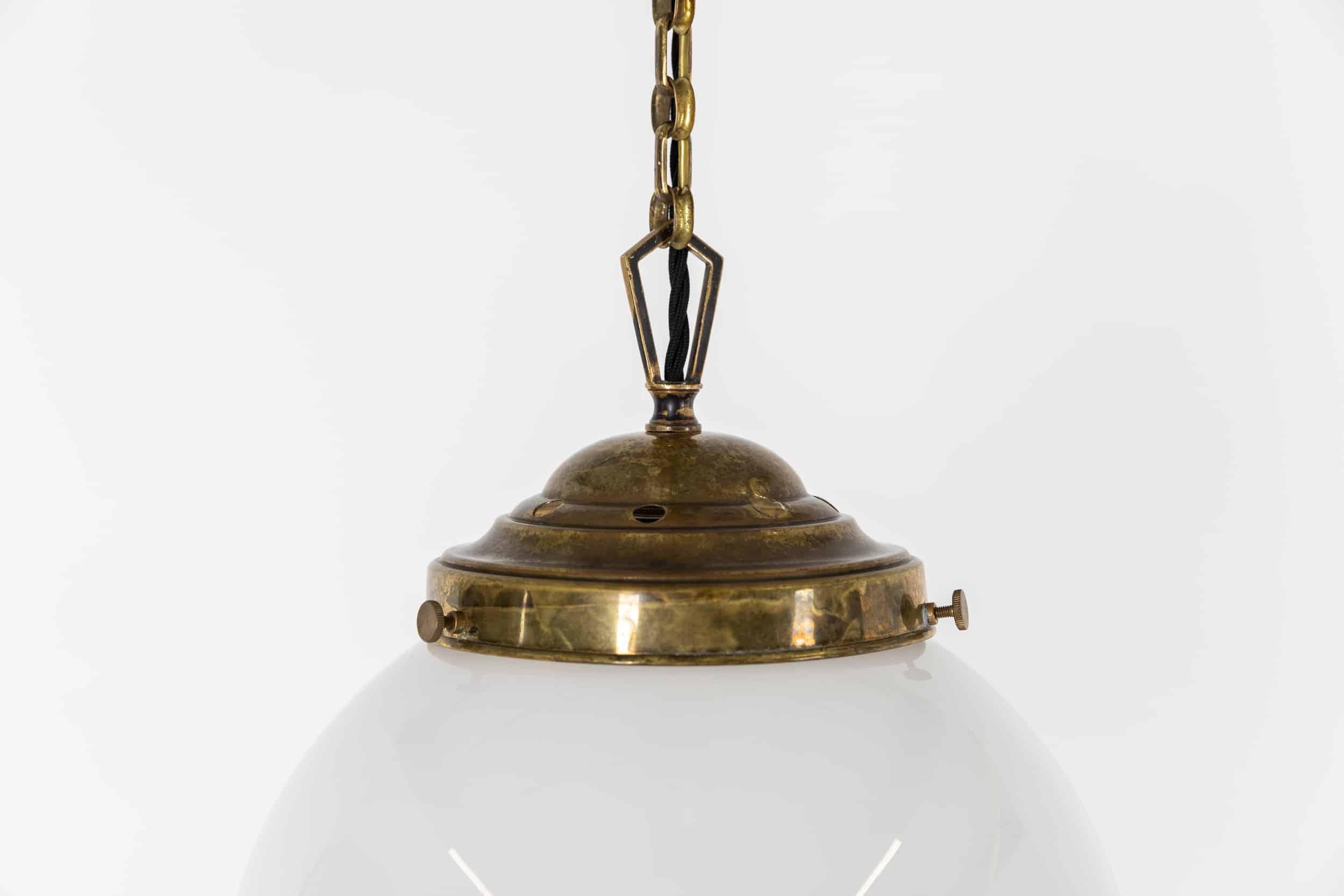 A single and large art deco globe opaline lamp with brass gallery. c.1930

Hand blown and rolled - this glass opaline light has beautiful form and shape, with original period brass gallery, chain and ceiling canopy.

Rewired with 1m of black twisted