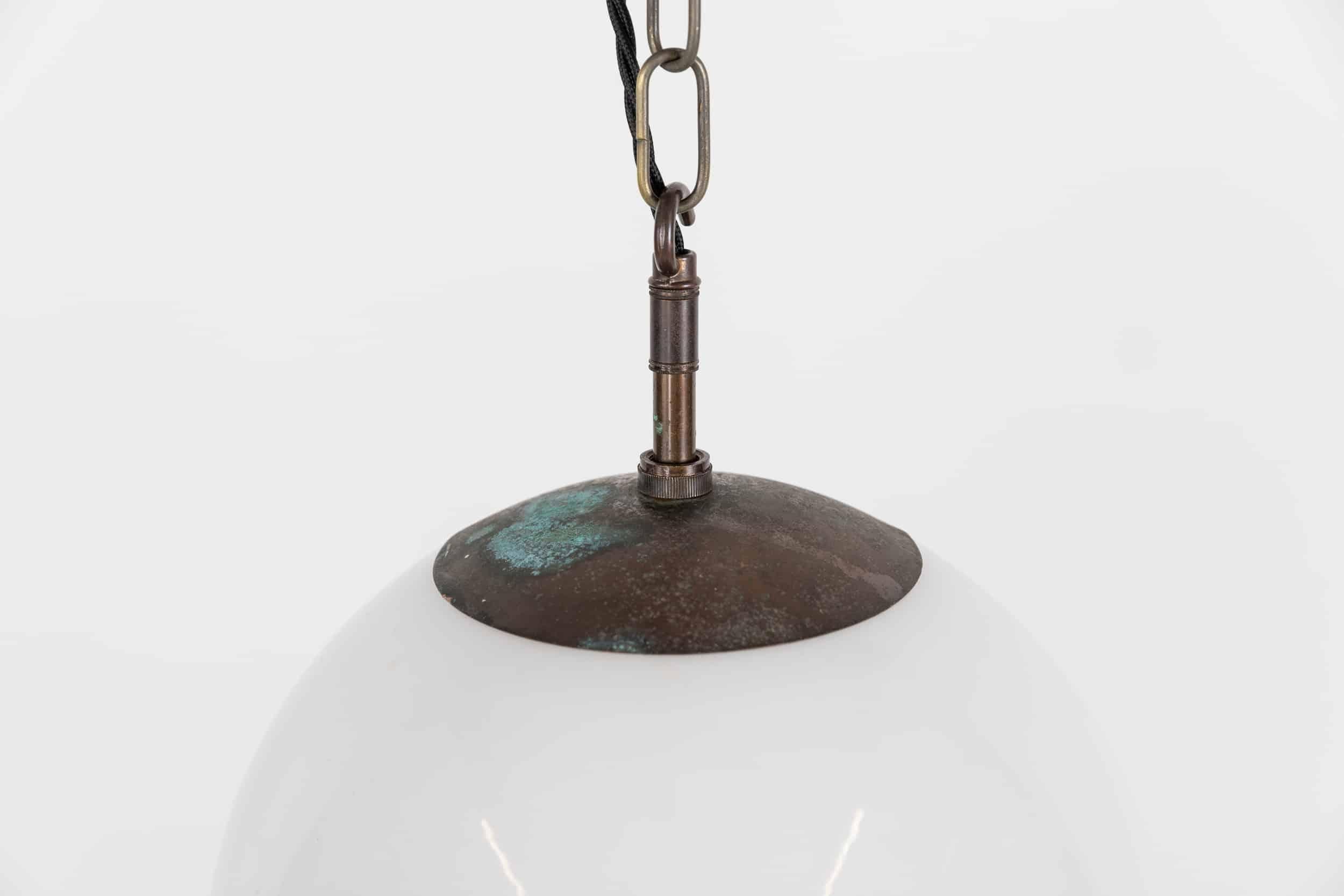 A single and large art deco globe opaline lamp with copper gallery. c.1930

Hand blown and rolled - this glass opaline light has beautiful form and shape, with copper verdigris monks cap gallery.

Rewired with 1m of black twisted flex.