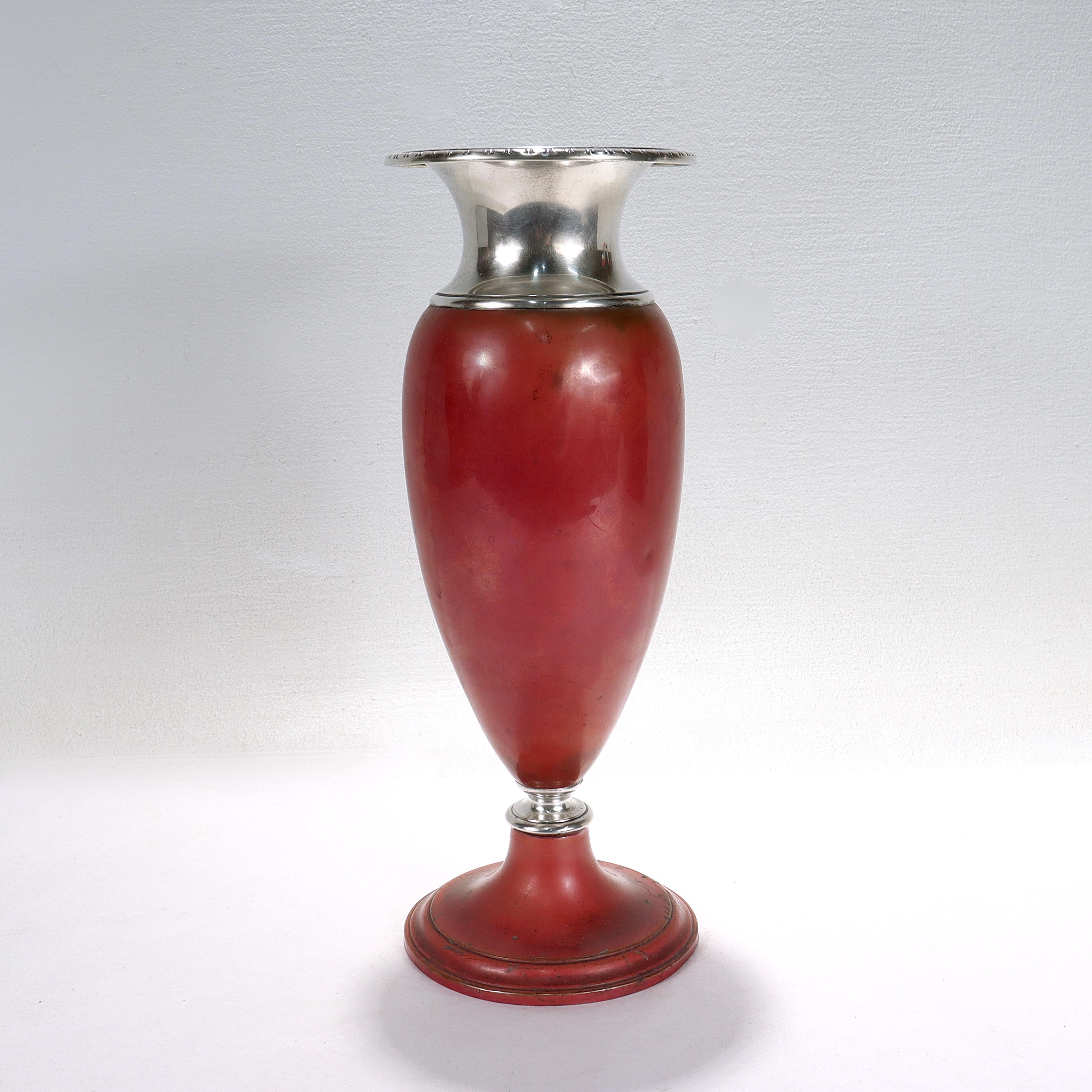 A fine Art Deco mixed metals vase.

From the La Pierre Manufacturing Company's 'Babylonian' line. 

In sterling silver and copper.

Consisting of a copper body with a wide sterling silver neck and rim and a sterling silver ferrule. 

With a lovely