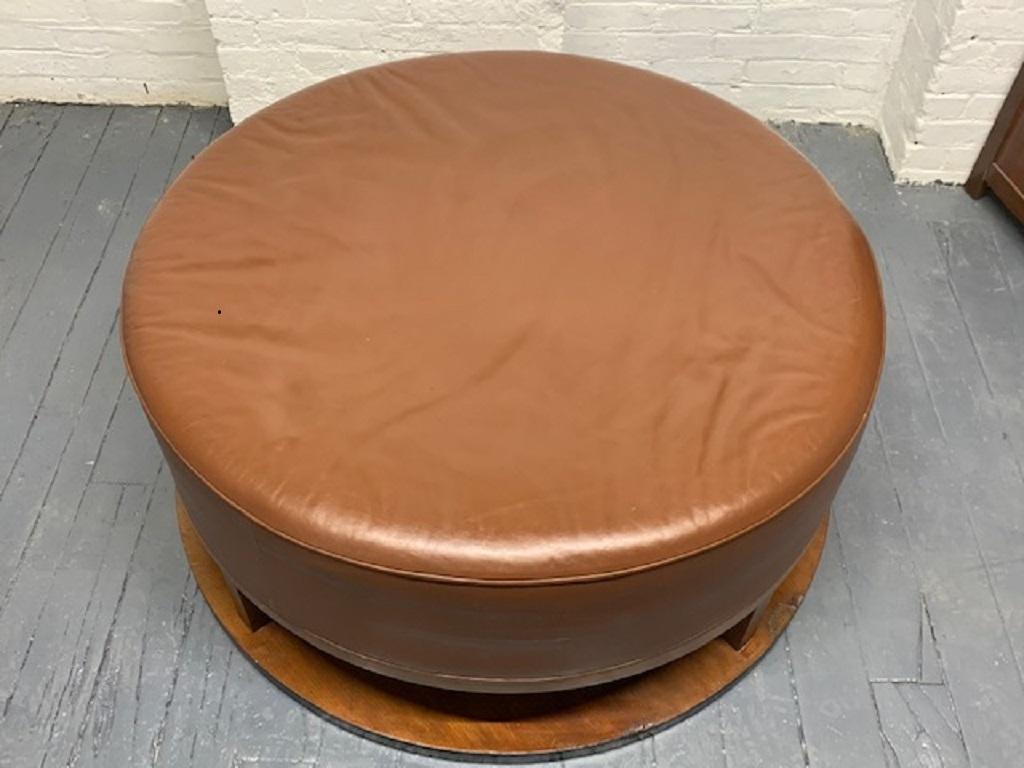 Large Art Deco, round leather ottoman with a walnut base.
 