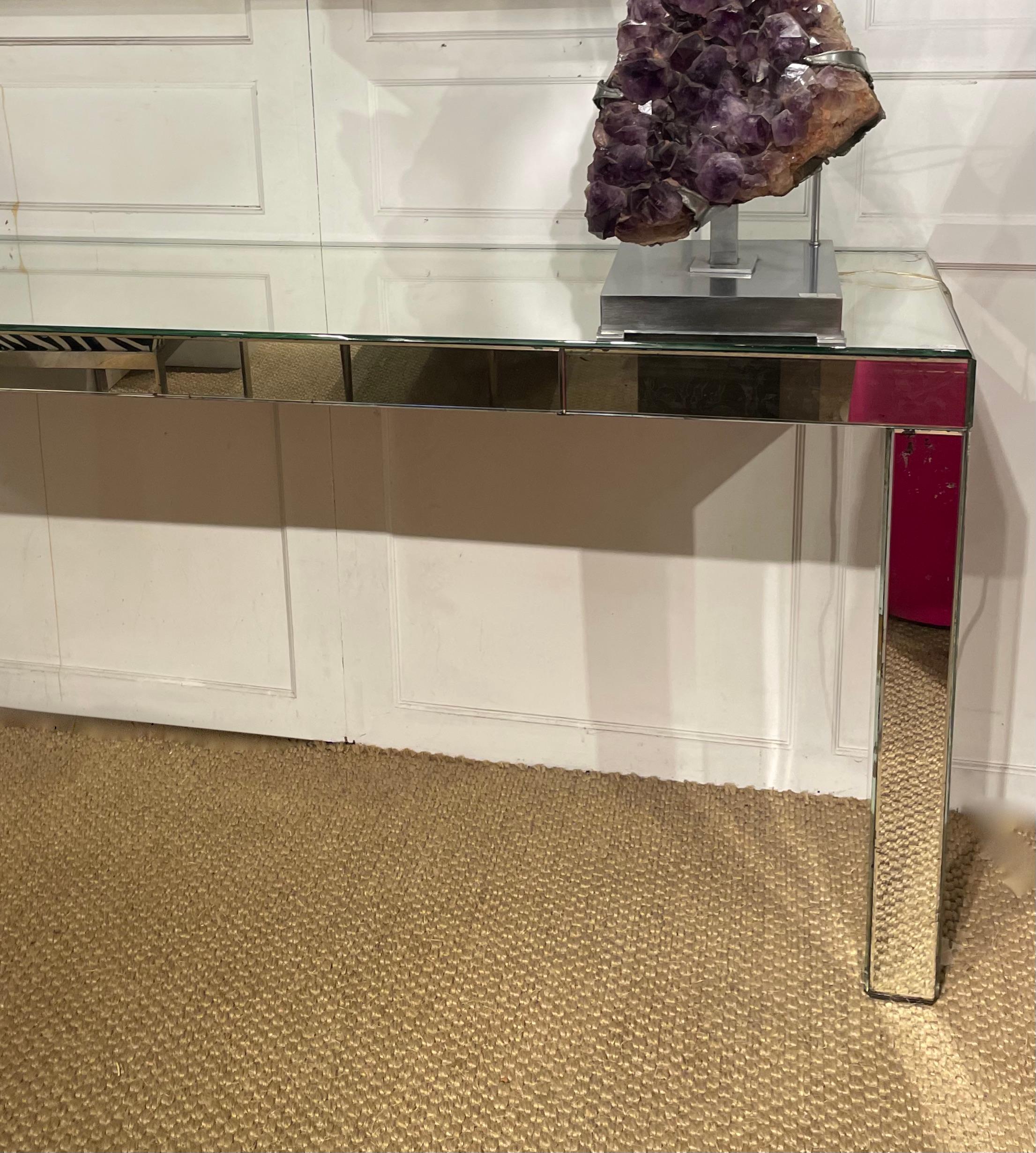 Large Art Deco  modernist wall console fully covered with mercury mirror.
Square feet. Some parts of the mirror are stained.
Attributed to Jacques Adnet- France-1930.