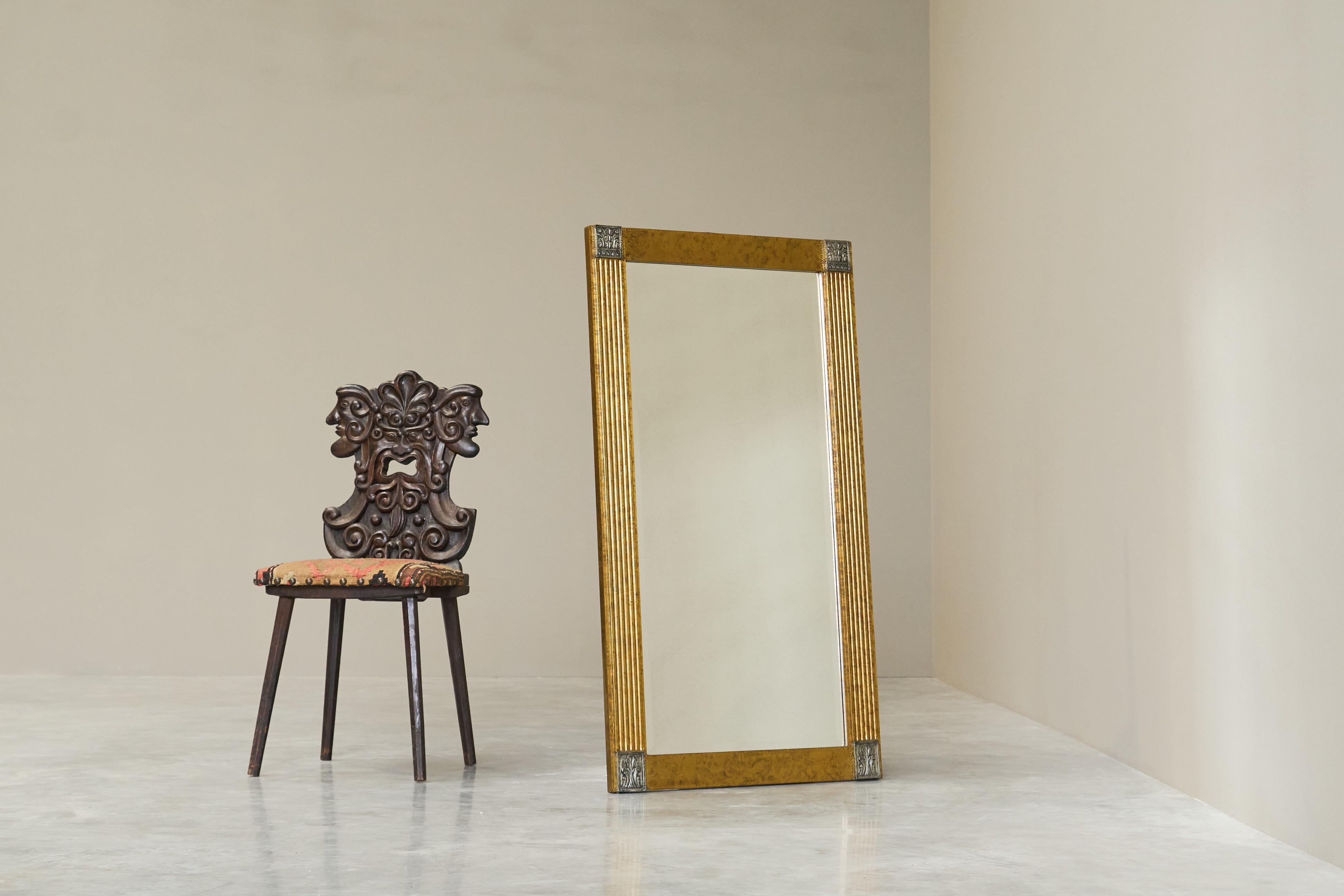 Large Art Deco Mirror in Patinated Brass with Facetted Mirror Glass 1960s.

A stunning and large art deco style mirror in patinated brass and facetted mirror glass. Wonderful art deco design with neoclassical influences - imposing piece. Great