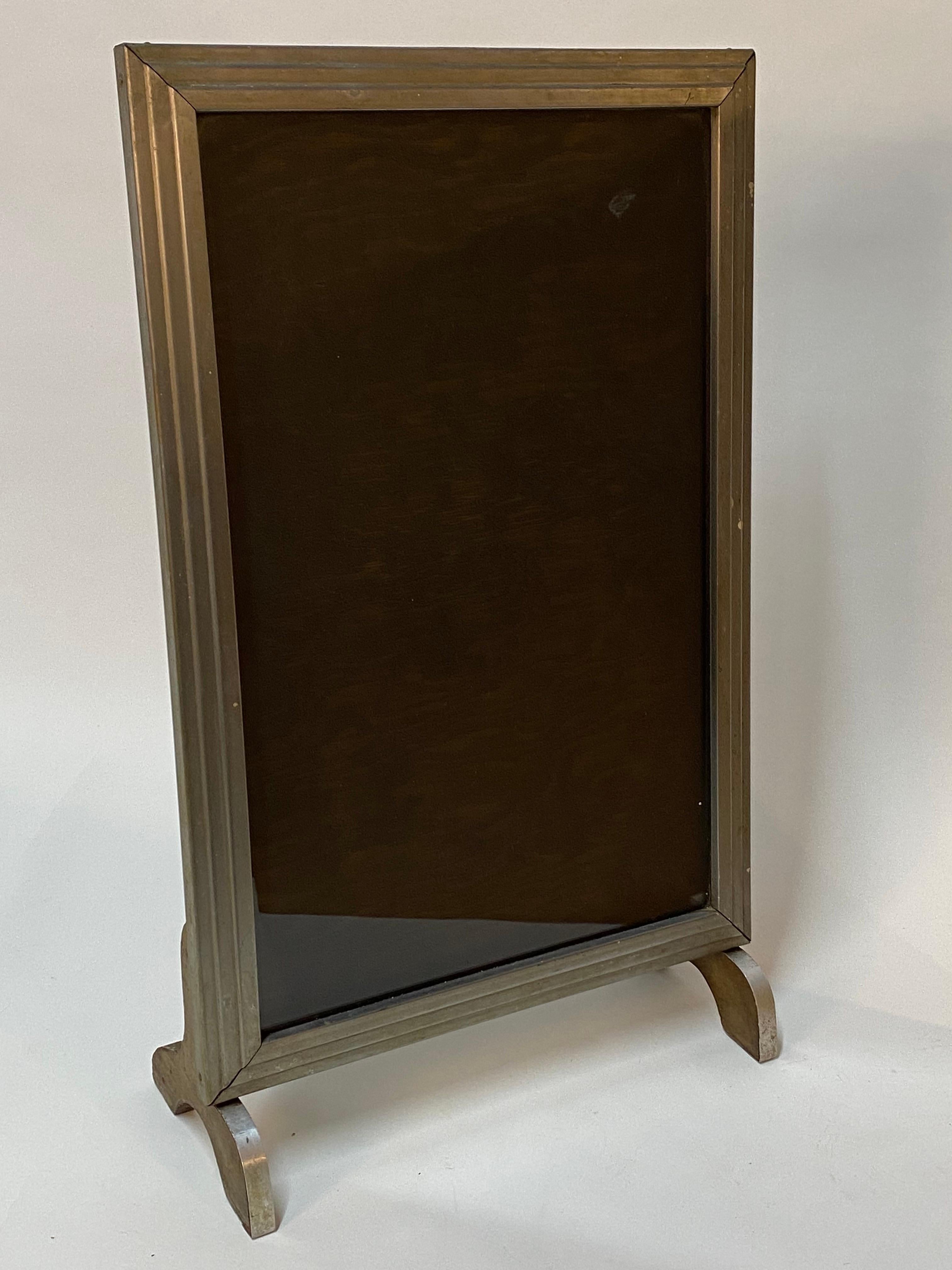 Exceptional stepped Art Deco nickel clad display frame. The nickel exterior covers the wood substrate and the fronts of the feet. The wood back is hinged and held in place with small flanges for ease of use and the graphics are under glass. Due to