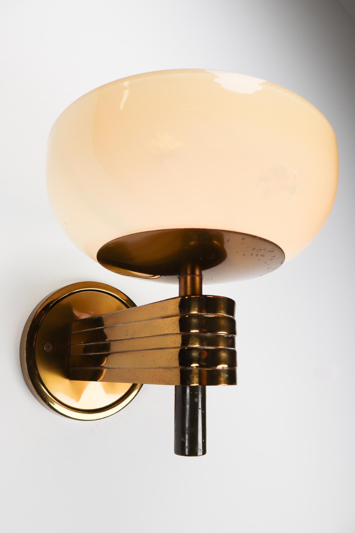 Large Art-Deco sconces with opaline glass and brass manufactured in Germany 1930s. The pleasant light it spreads is very atmospheric, these wall scones will contribute to a luxurious character of the (hotel-bar) interior. Good original condition